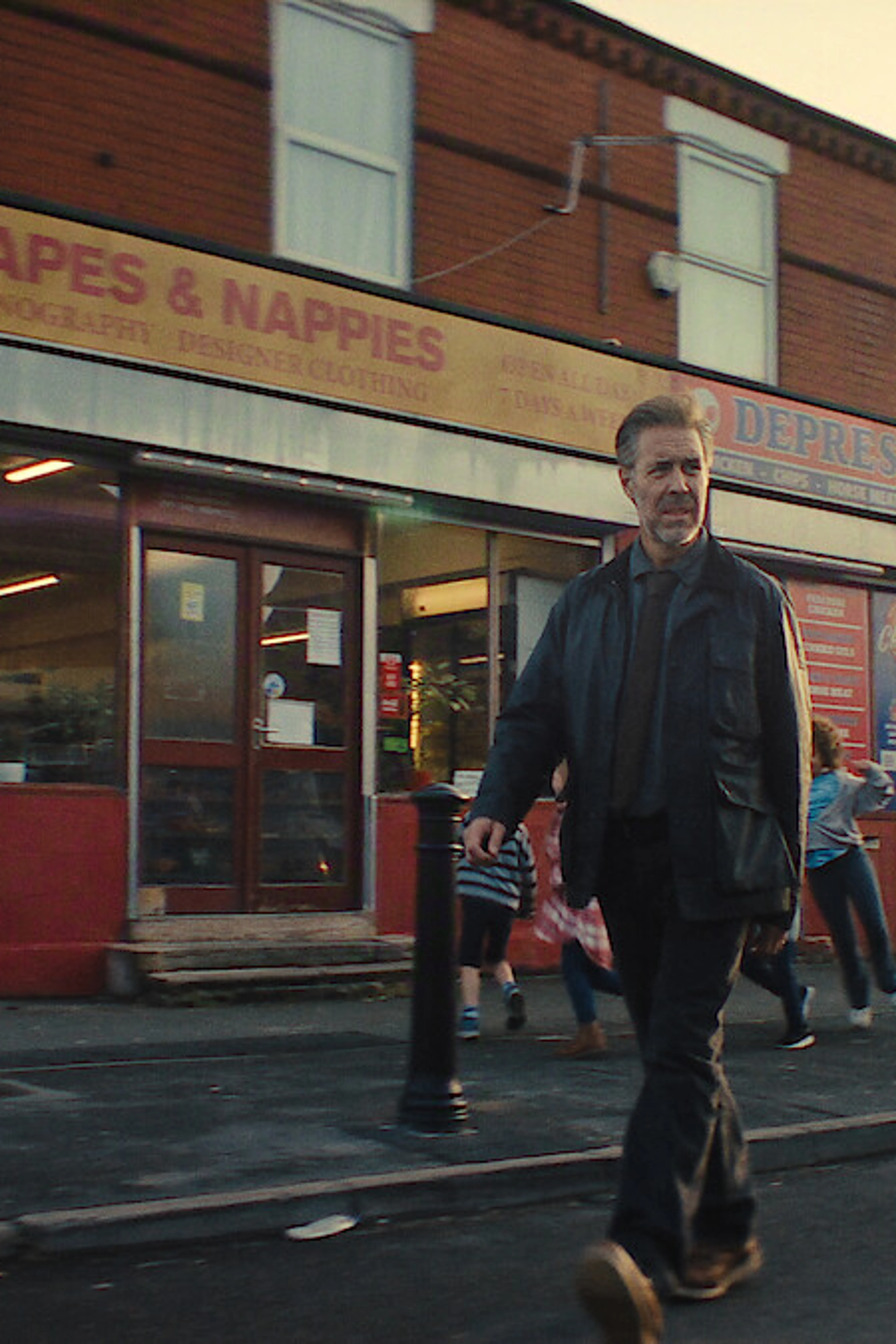 Paddy Considine as Detective John Blackmere walks along a city street in Netflix’s first-look image.