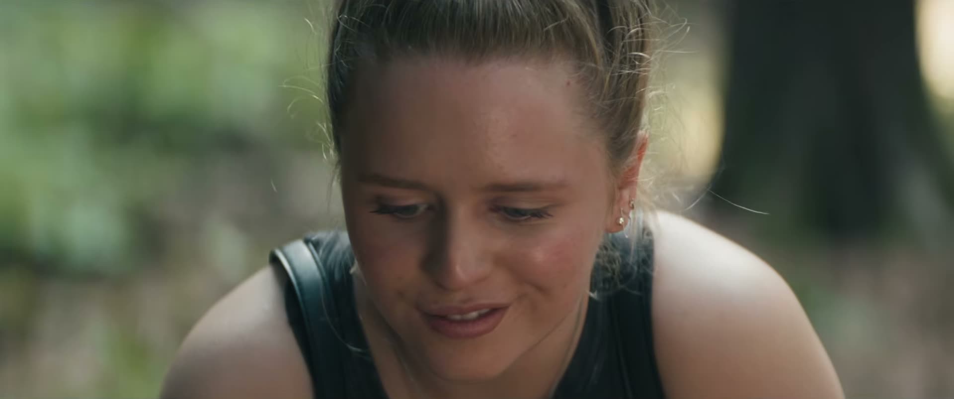 Lulu Wilson as Becky Hooper, looking down with her blonde hair tied back.