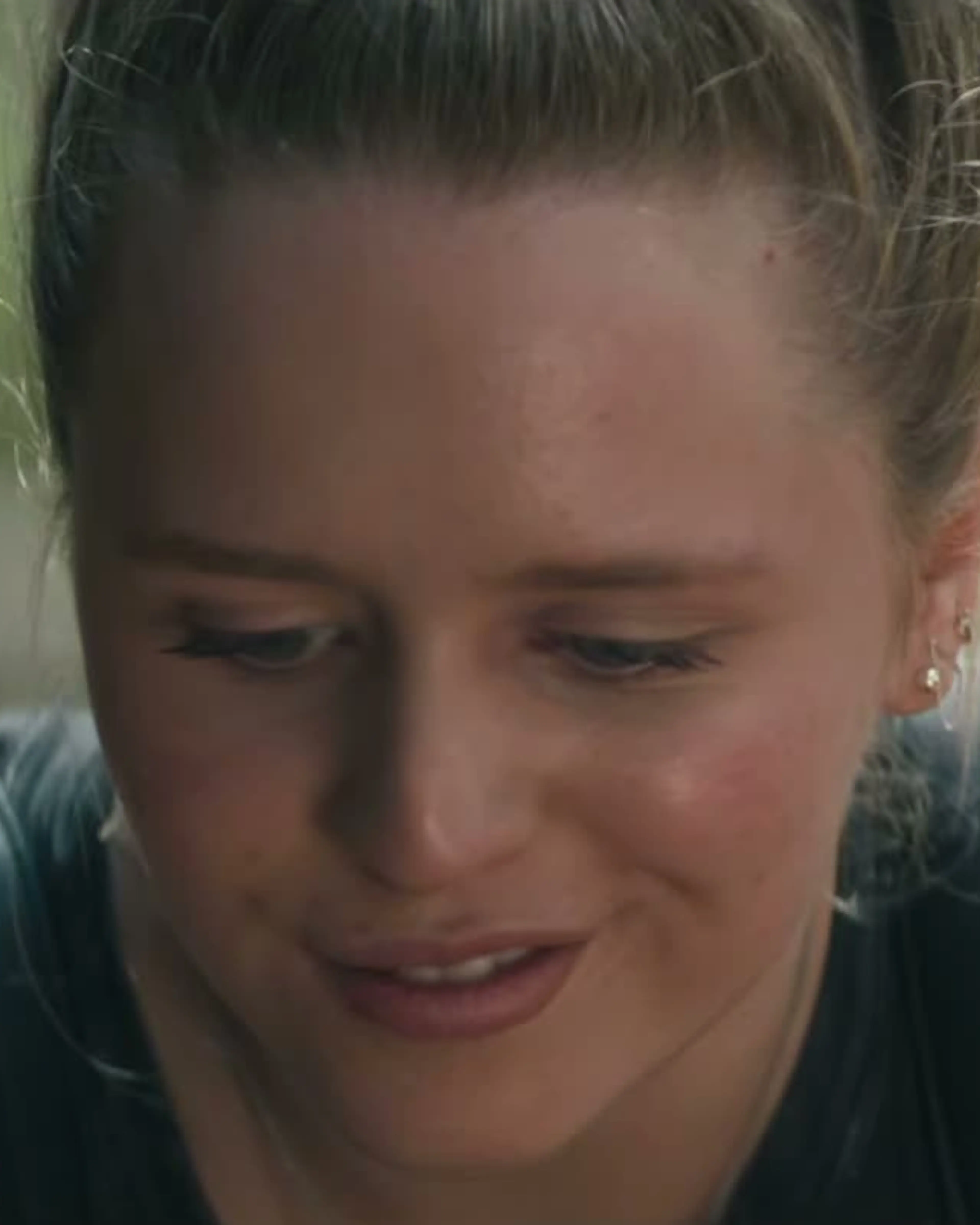 Lulu Wilson as Becky Hooper, looking down with her blonde hair tied back.