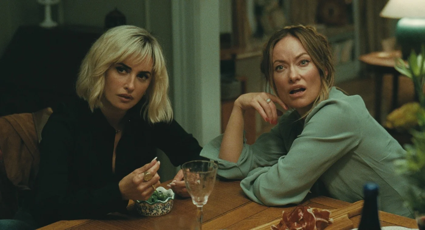 Piña and Angela sit next to each other at the dining table.