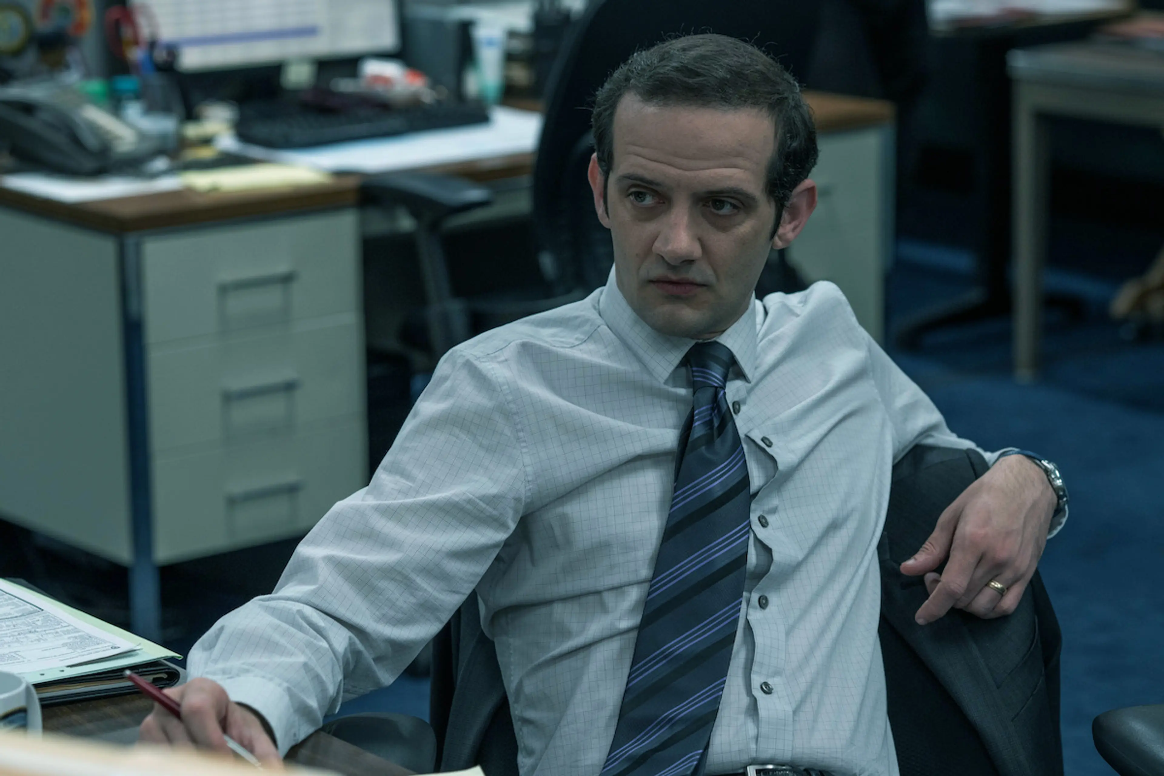 Will Brill as Sergeant John Dyson sits in a police office in The Whisper Man.