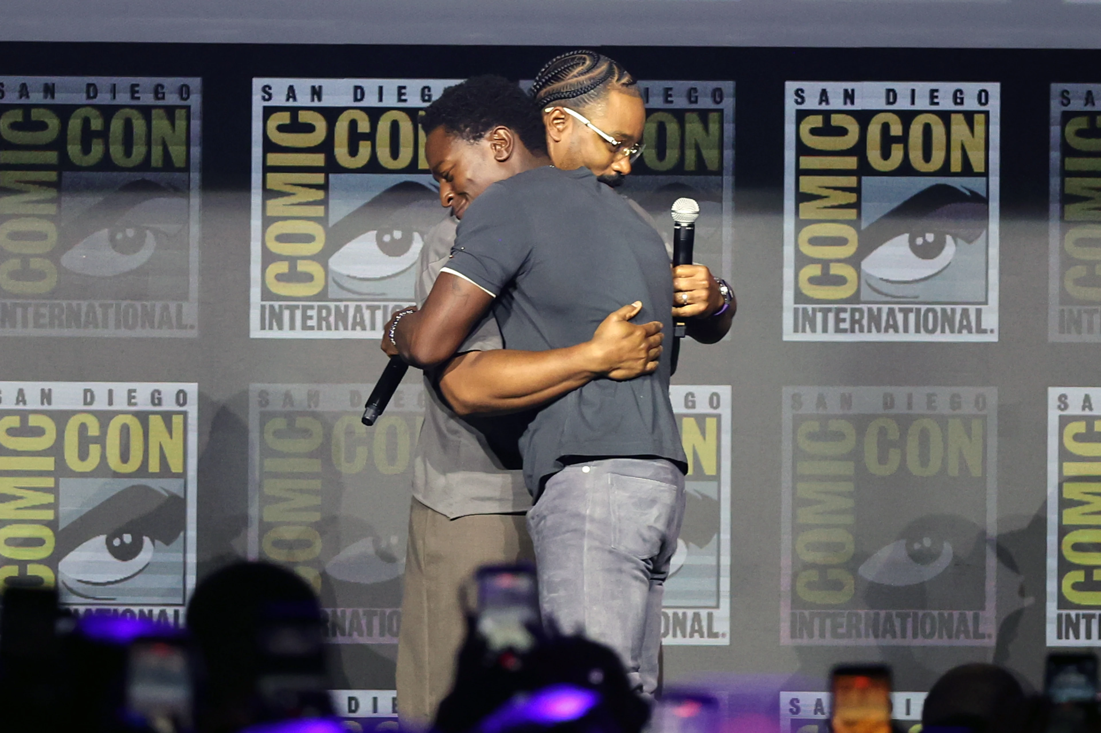 David Jonsson hugs director Ryan Coogler during Marvel Studios’ Black Panther 3 presentation.