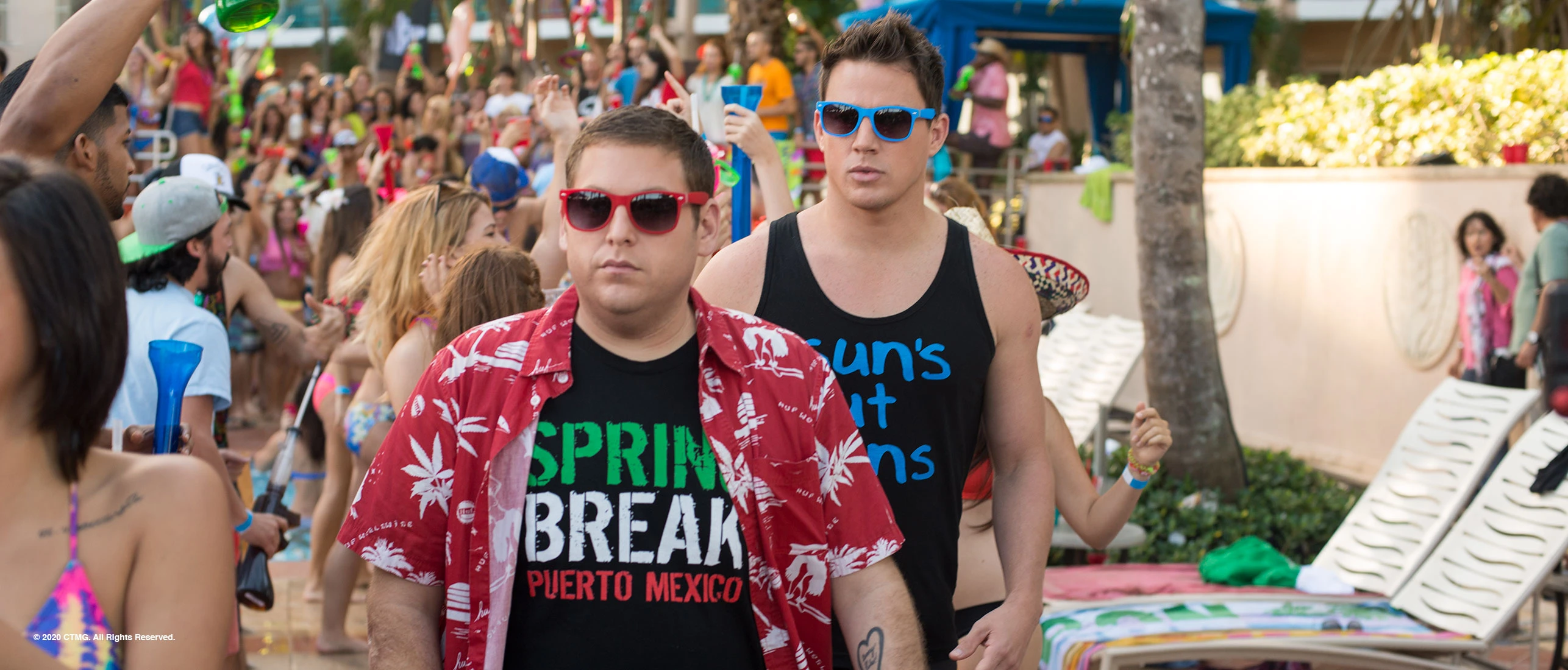 Jonah Hill and Channing Tatum walk through a crowded spring break party in 22 Jump Street.