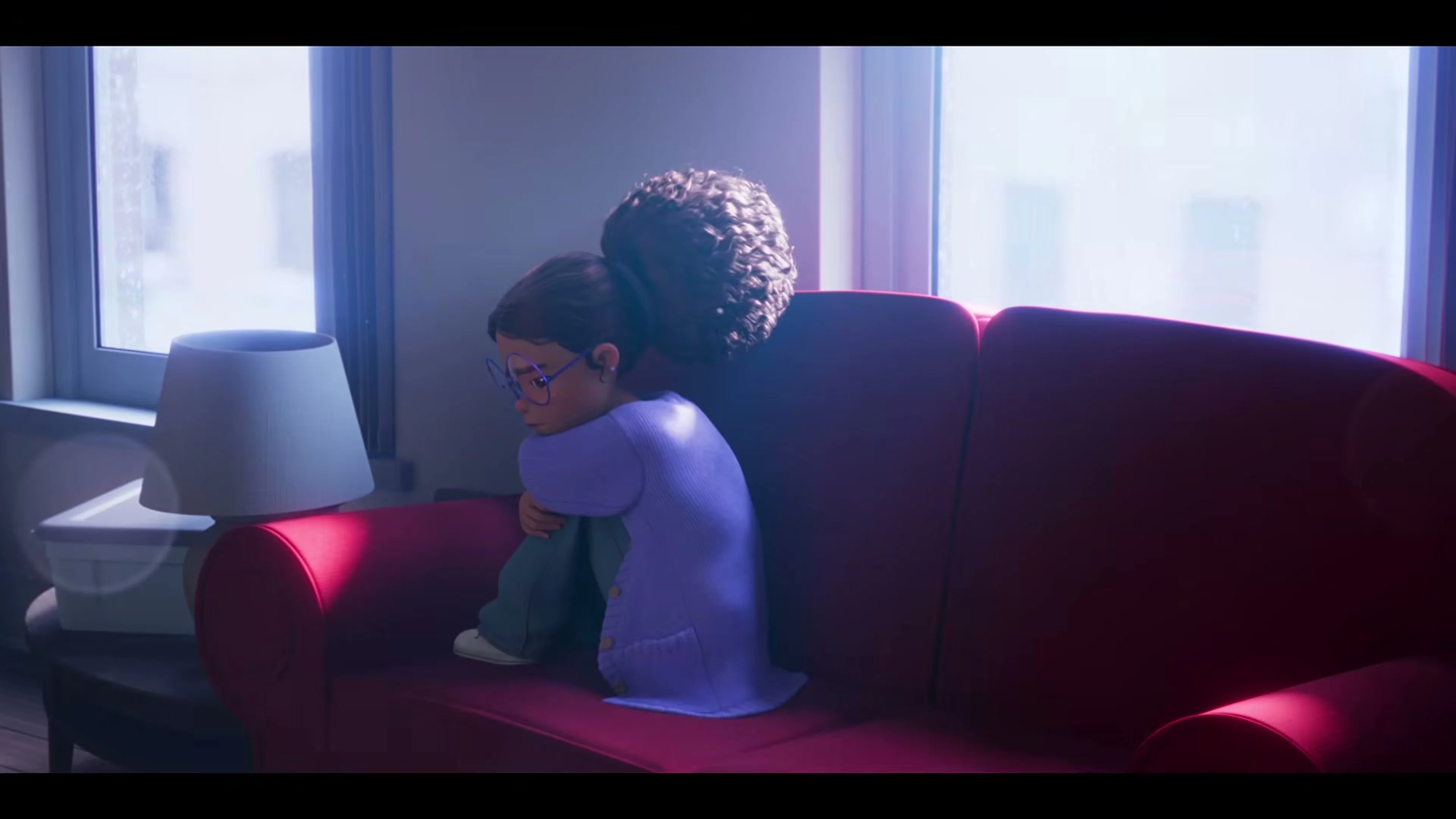 Gabby and Sebastian sit close together on a couch in a new home in The Cat in the Hat main trailer.