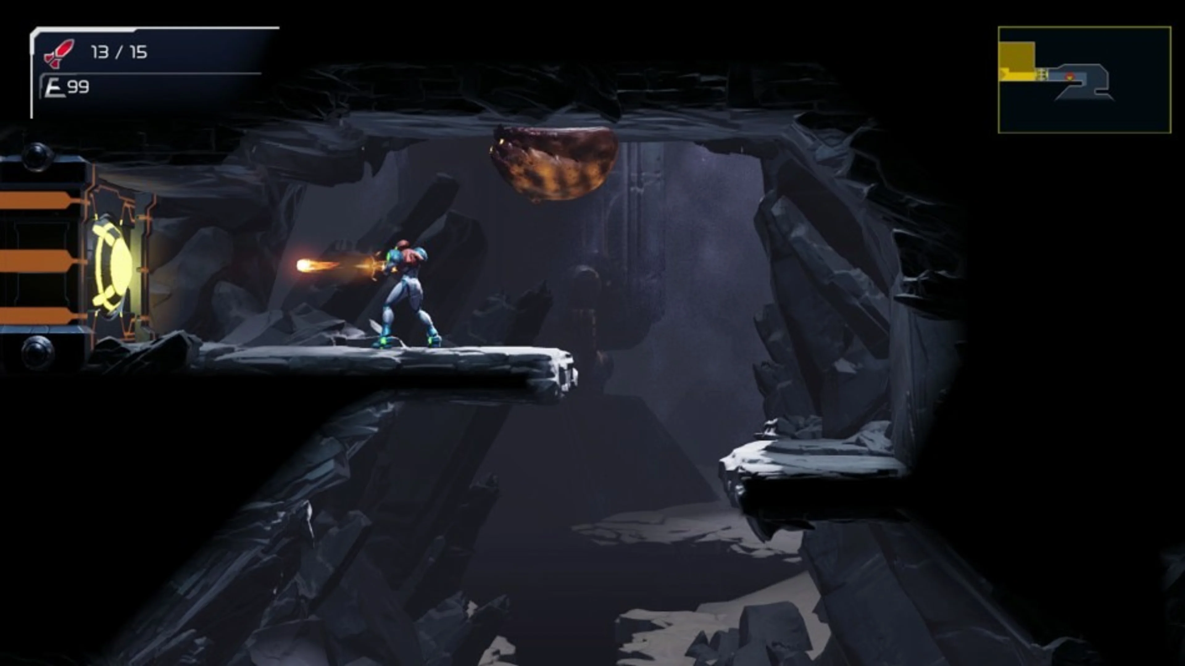 Samus fires at a yellow-lit Beam Door on the left edge of a rocky corridor.