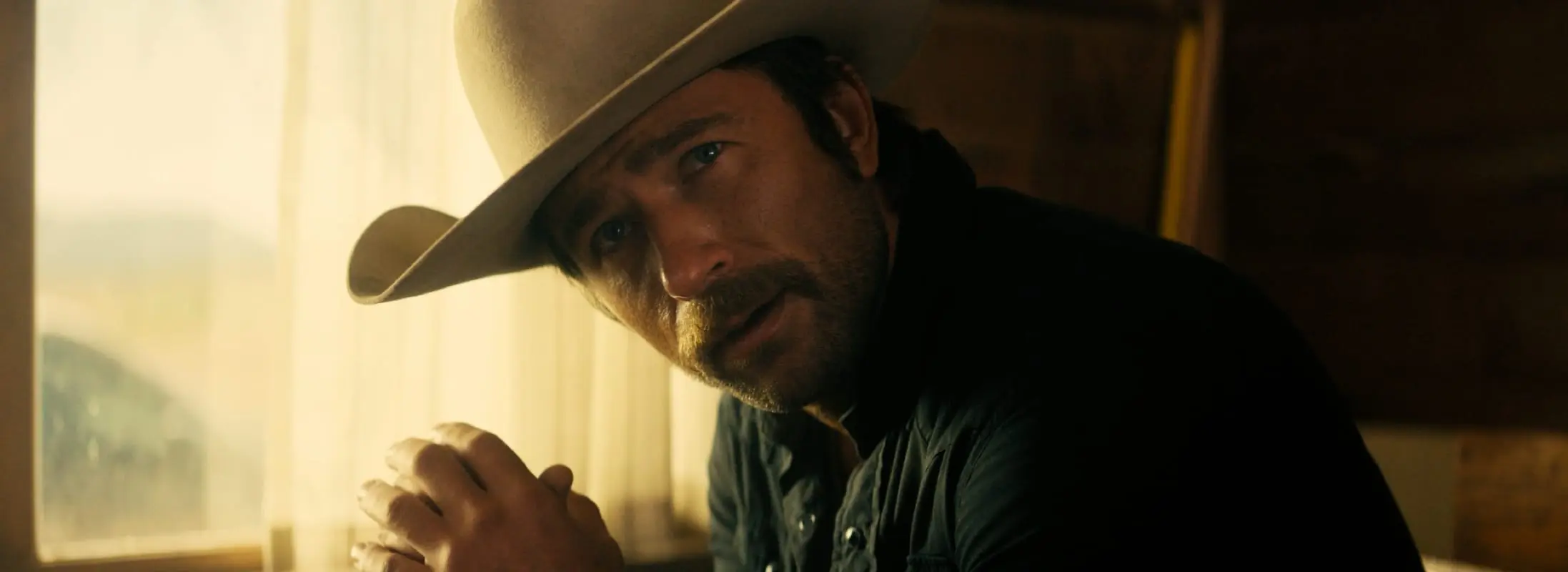 Brandon Sklenar in a cowboy hat in The Rescue.