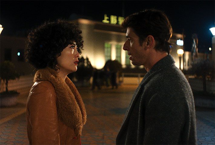 Rinko Kikuchi and a man talk outdoors at night in Ha-Chan, Shake Your Booty!