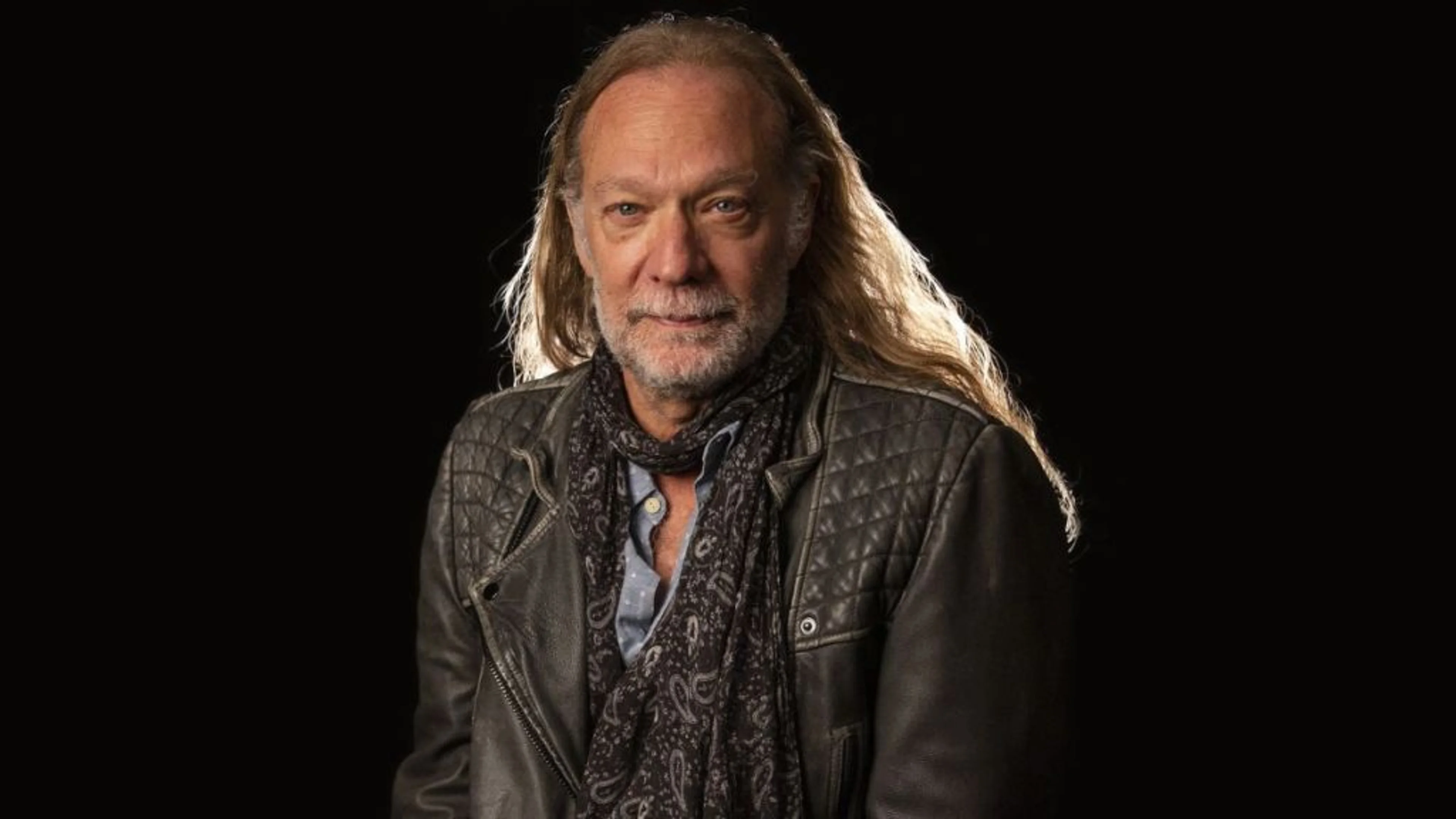 Greg Nicotero poses for a portrait against a dark background.