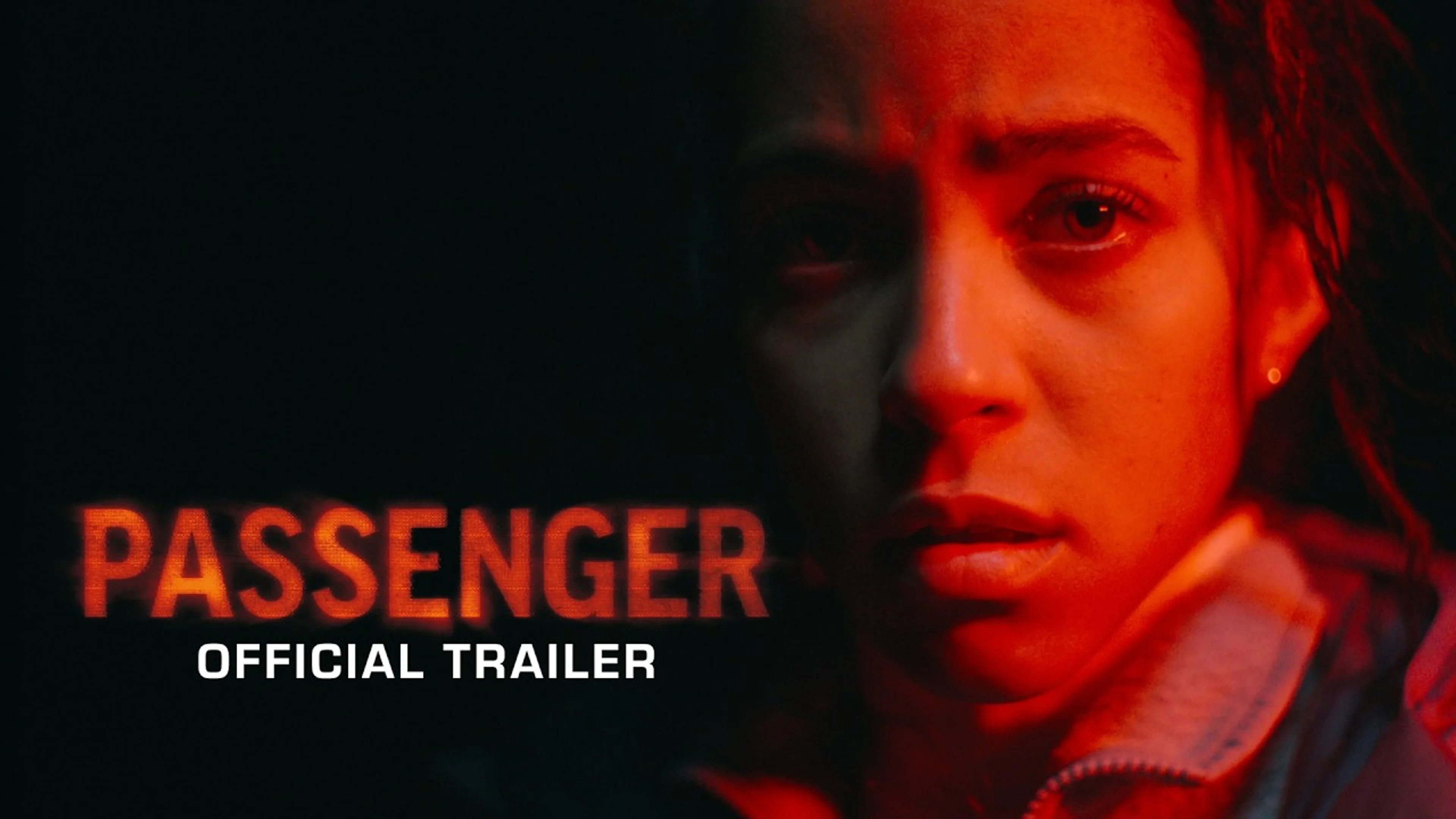 The official Passenger trailer image shows a woman lit in red beside the film title.