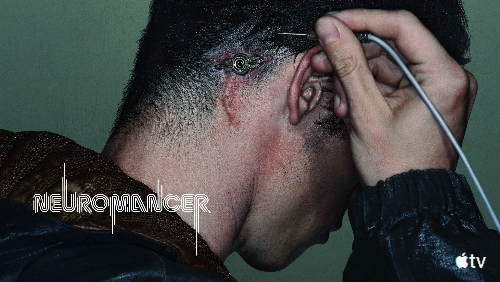 Callum Turner as Case connects a cable behind his ear in official Neuromancer key art.