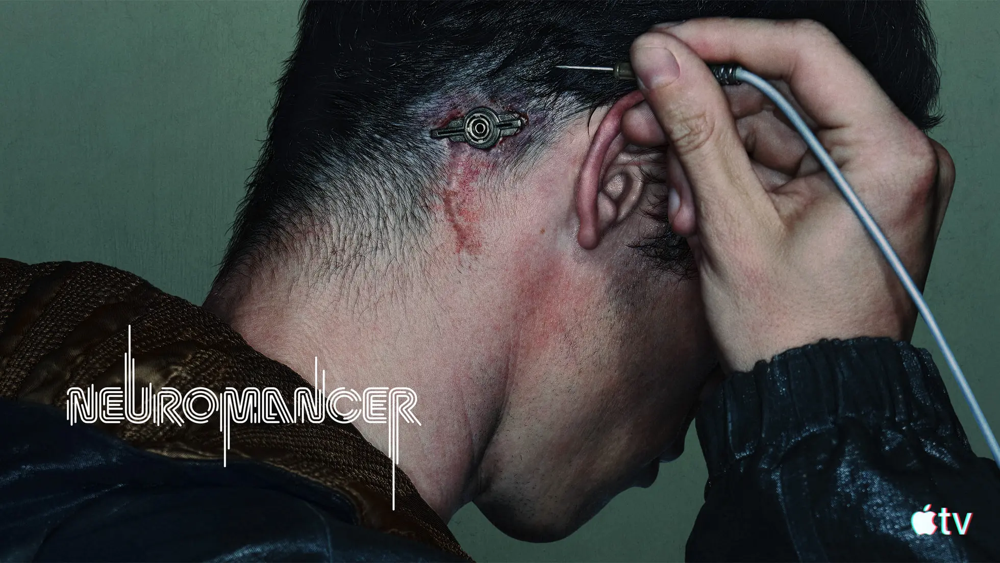 Callum Turner as Case connects a cable behind his ear in official Neuromancer key art.