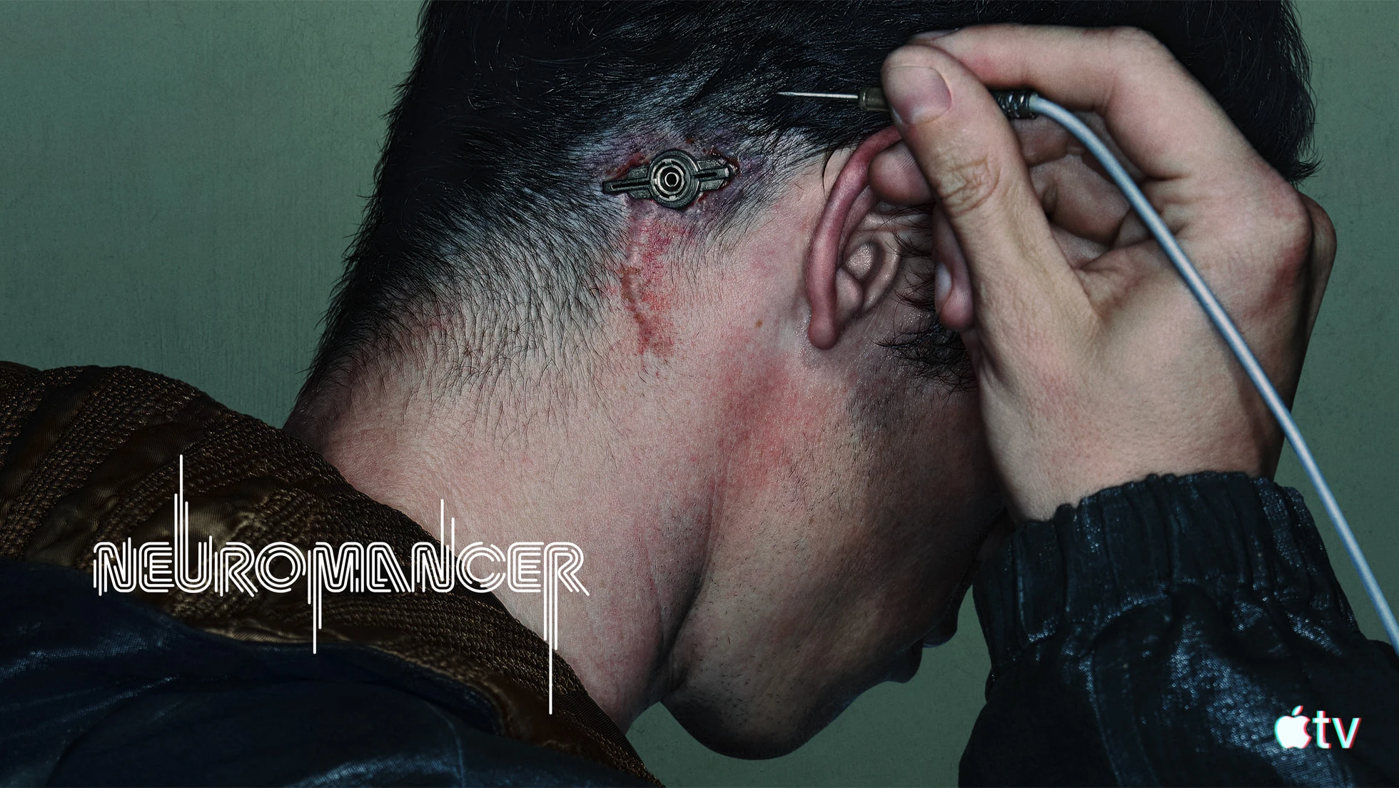 Callum Turner as Case connects a cable behind his ear in official Neuromancer key art.