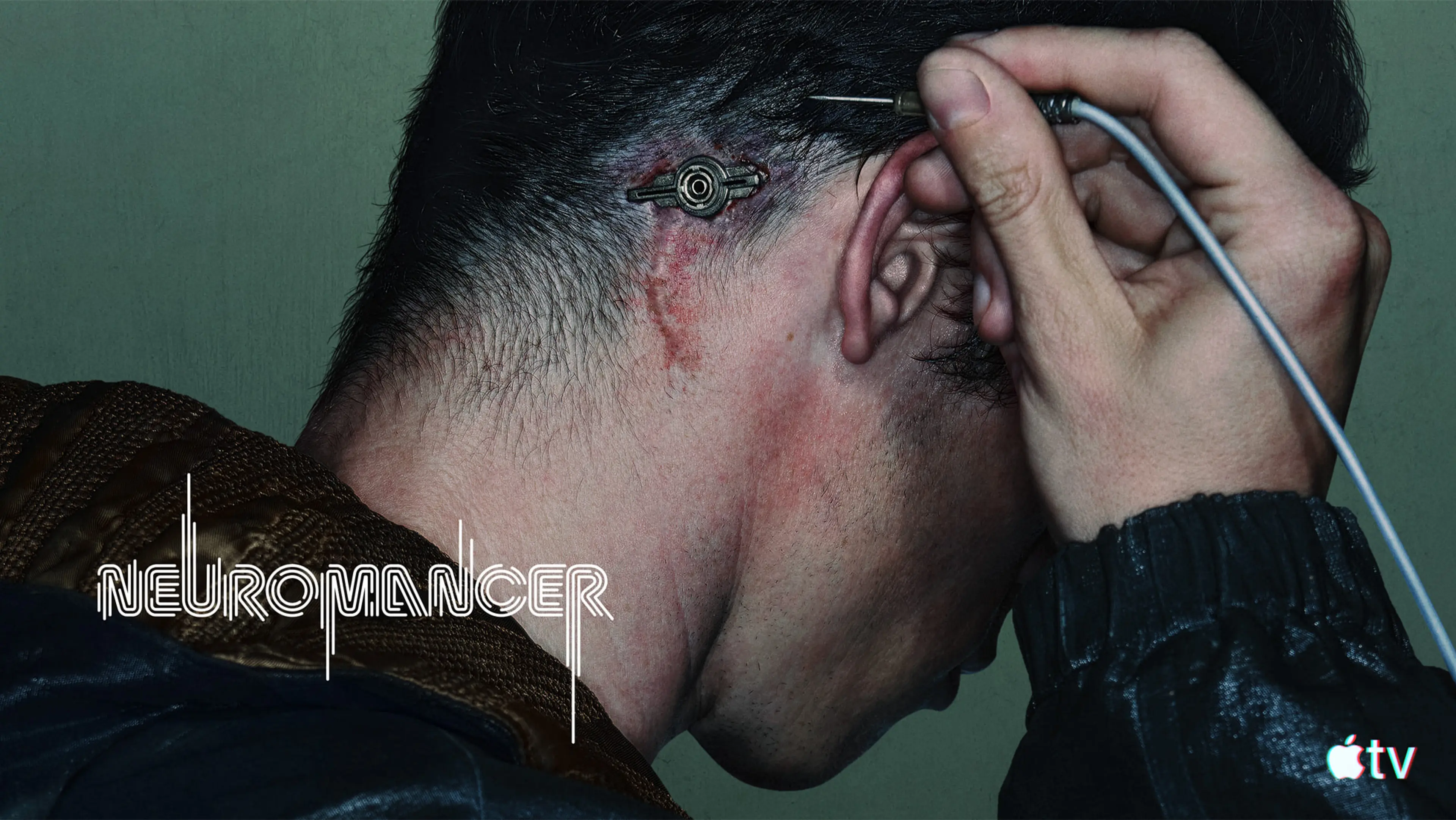 Callum Turner as Case connects a cable behind his ear in official Neuromancer key art.