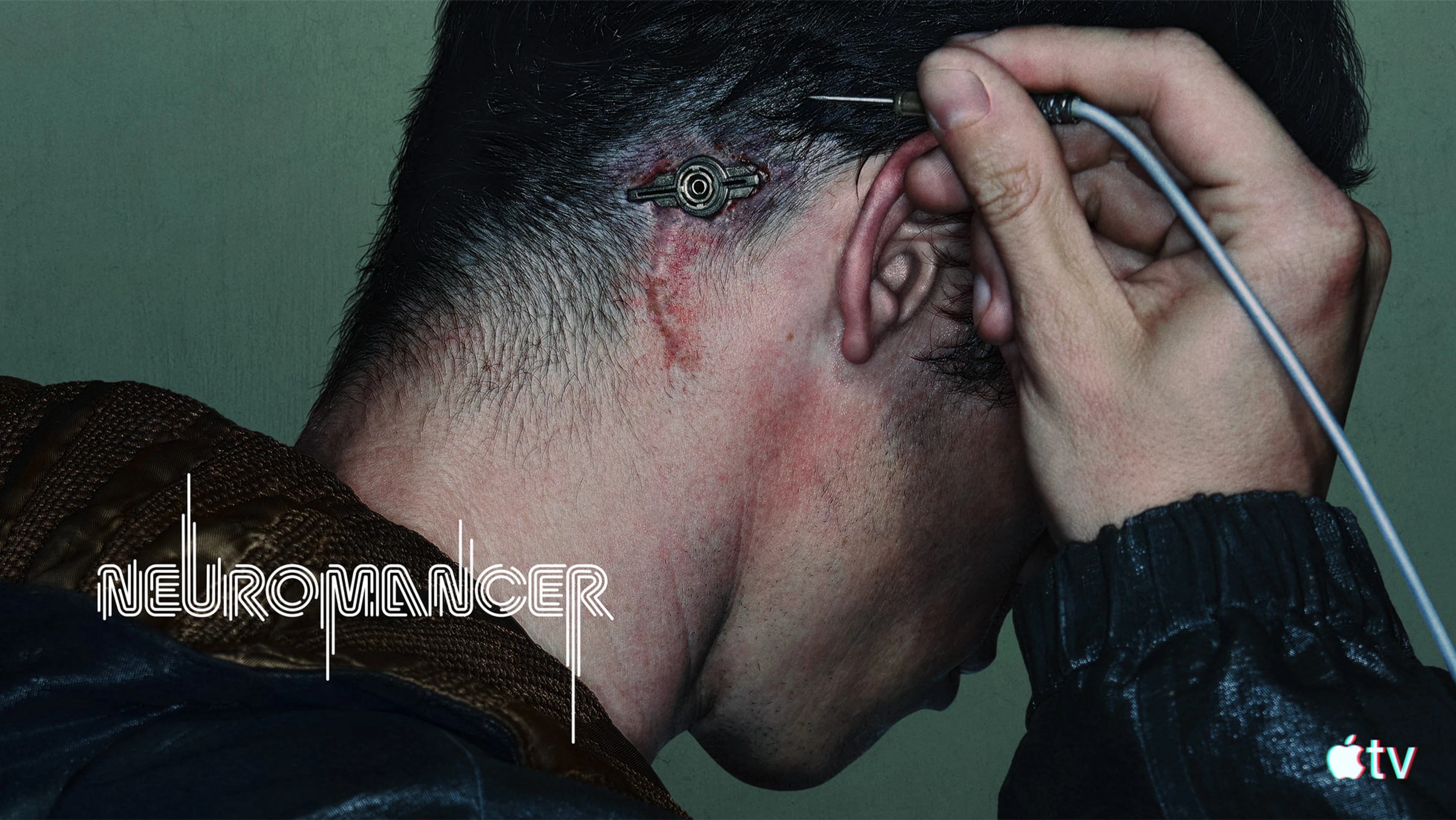 Callum Turner as Case connects a cable behind his ear in official Neuromancer key art.