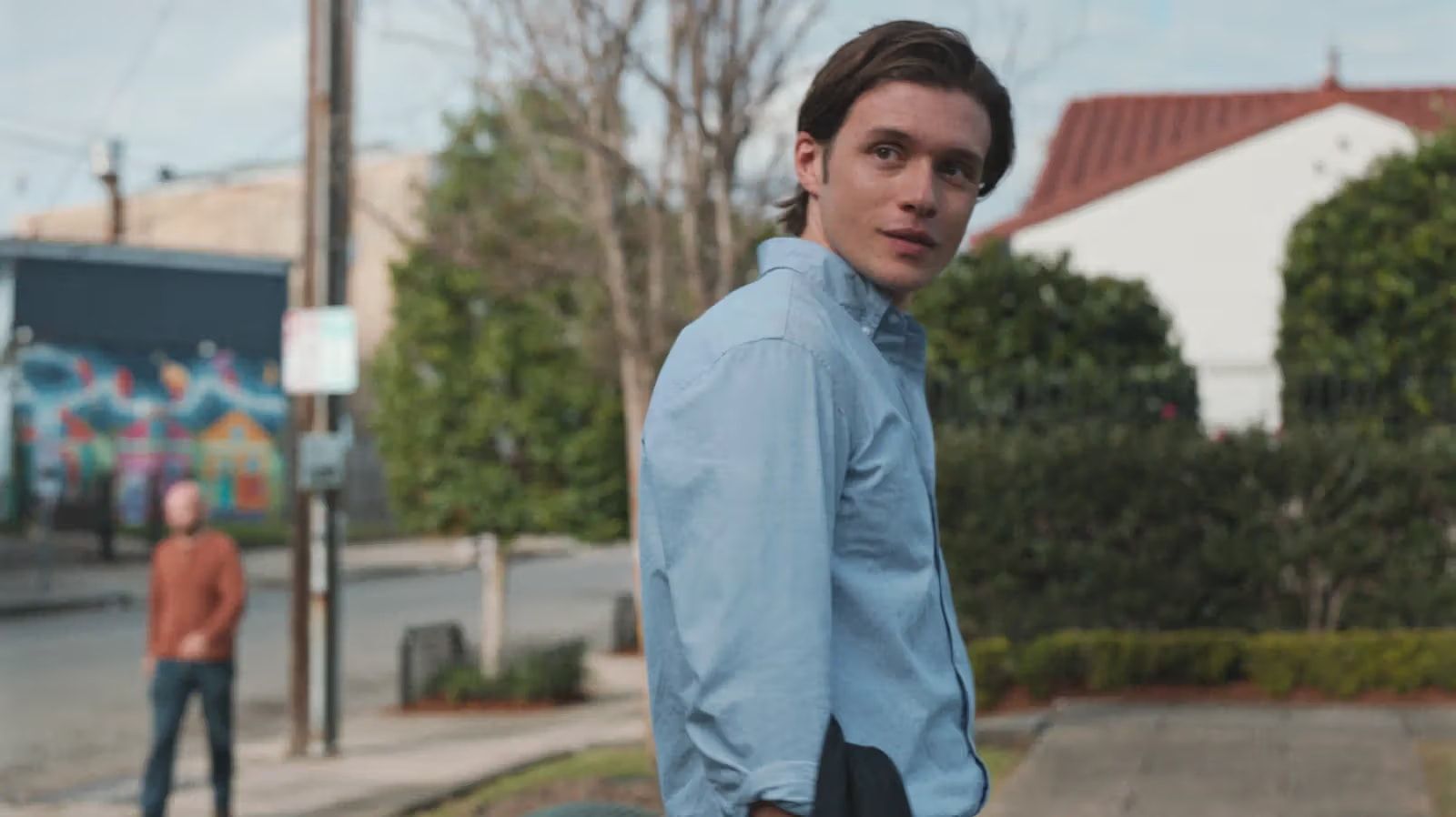 Nick Robinson as Charlie looks back on a suburban street.