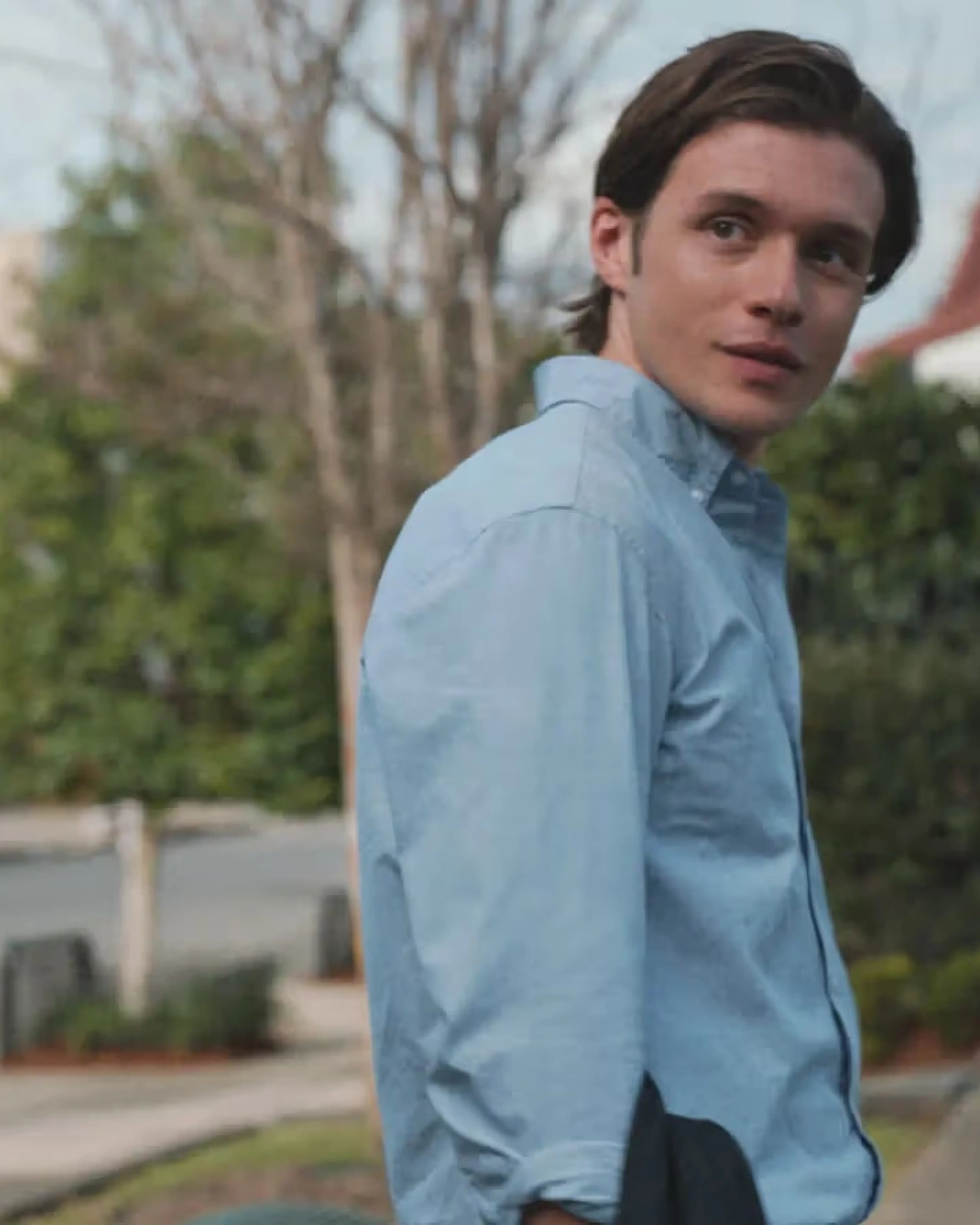 Nick Robinson as Charlie looks back on a suburban street.