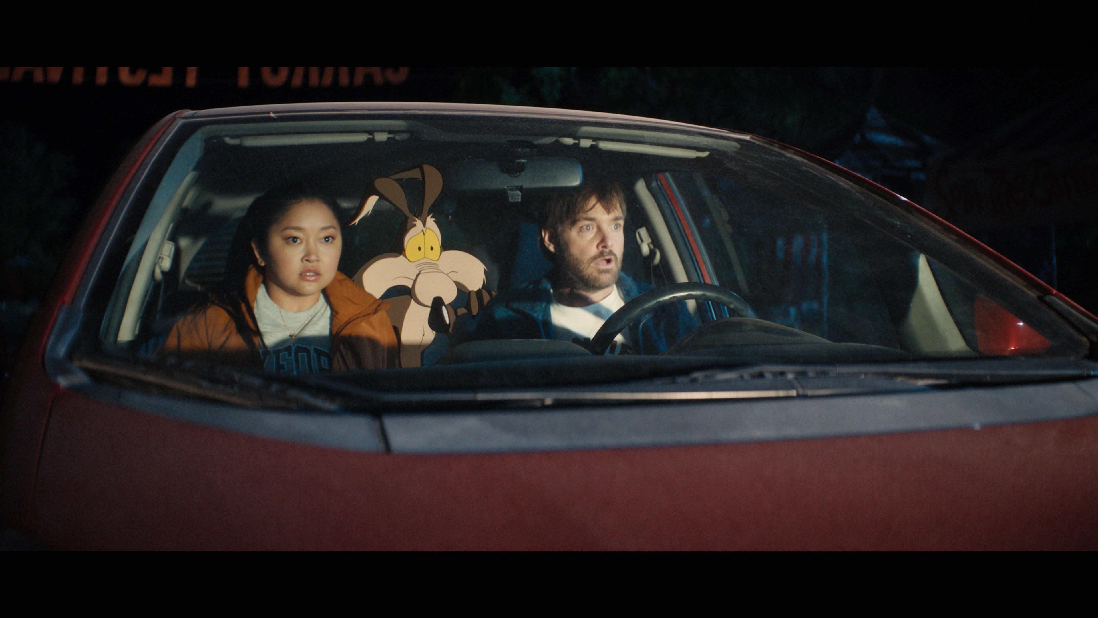 Lana Condor, Wile E. Coyote, and Will Forte riding in a car in Coyote vs. Acme.