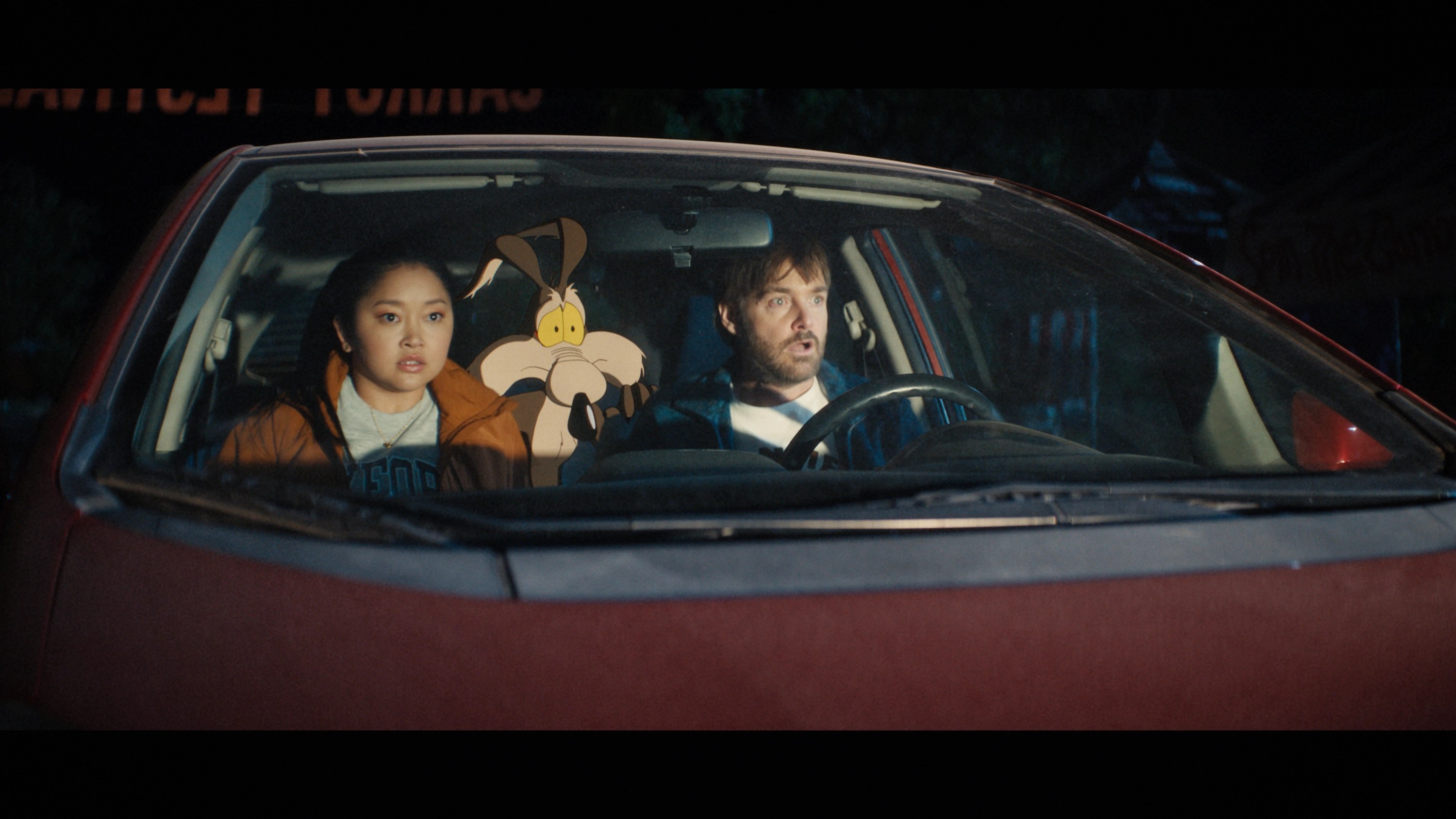 Lana Condor, Wile E. Coyote, and Will Forte riding in a car in Coyote vs. Acme.