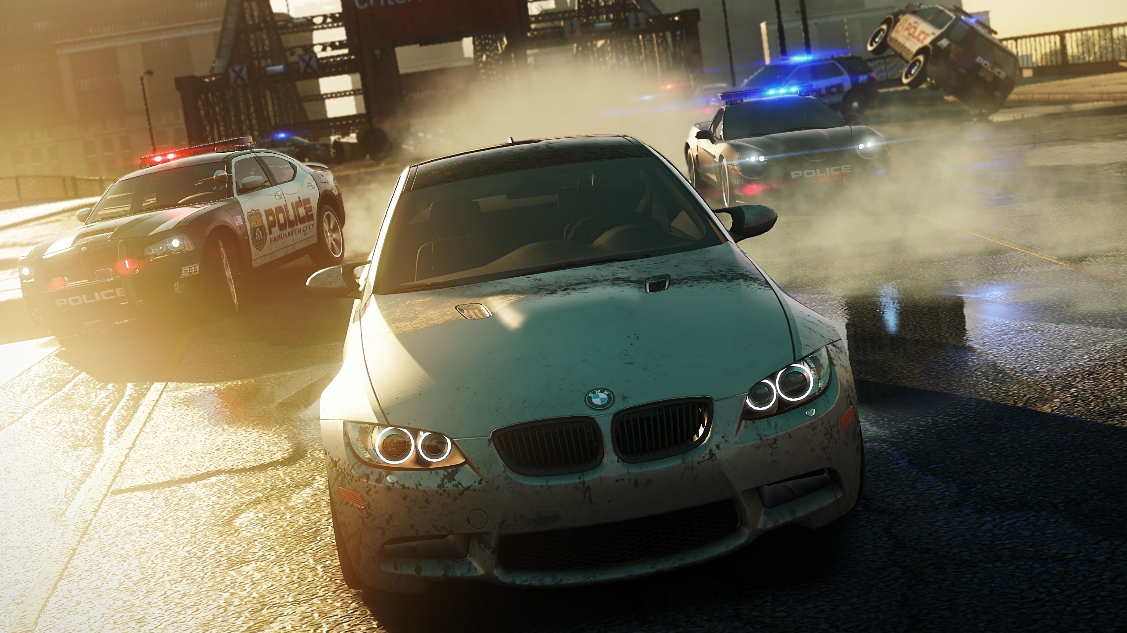 White BMW races ahead of several police cars across a bridge in Most Wanted.