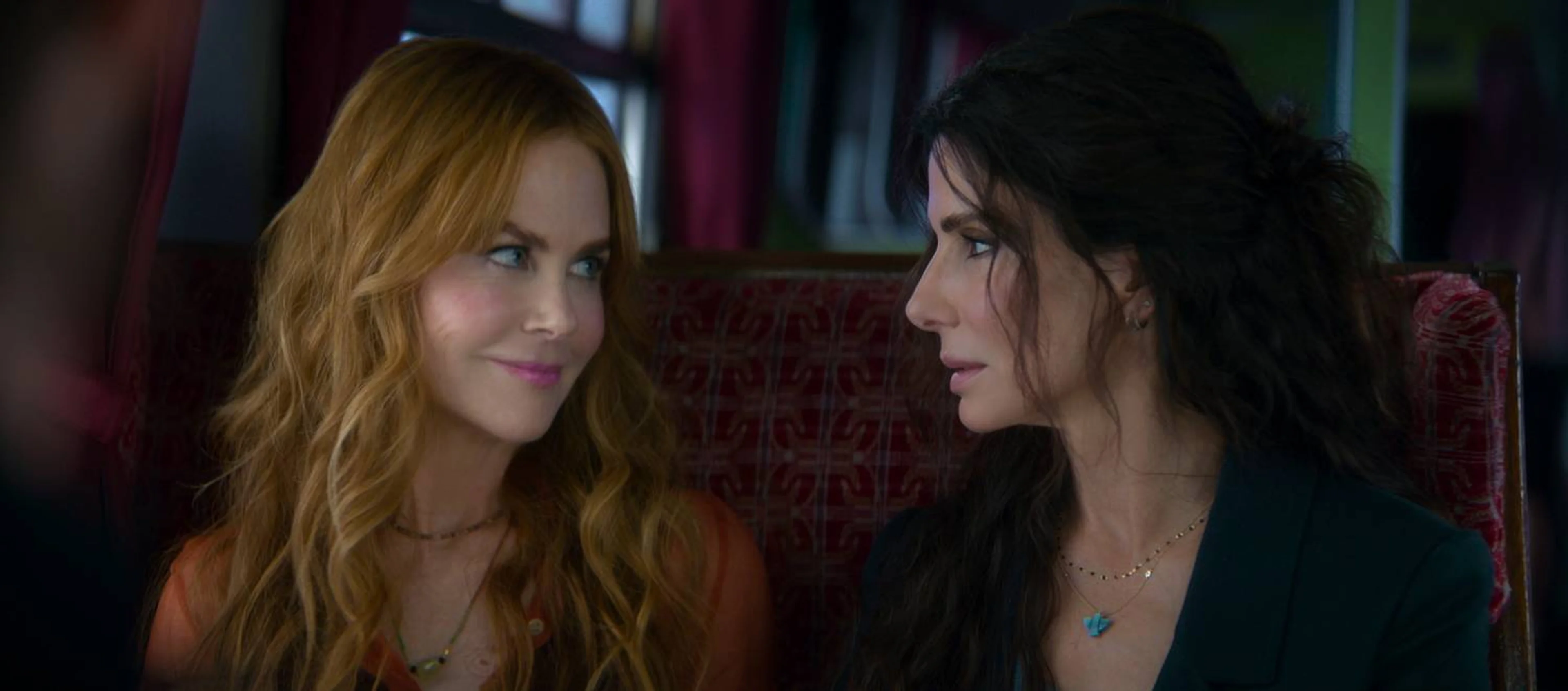 Sandra Bullock and Nicole Kidman sit together in a scene from Practical Magic 2.