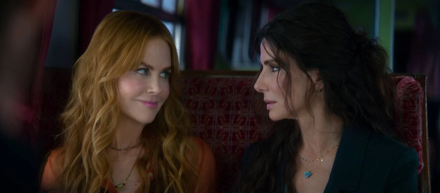 Sandra Bullock and Nicole Kidman sit together in a scene from Practical Magic 2.