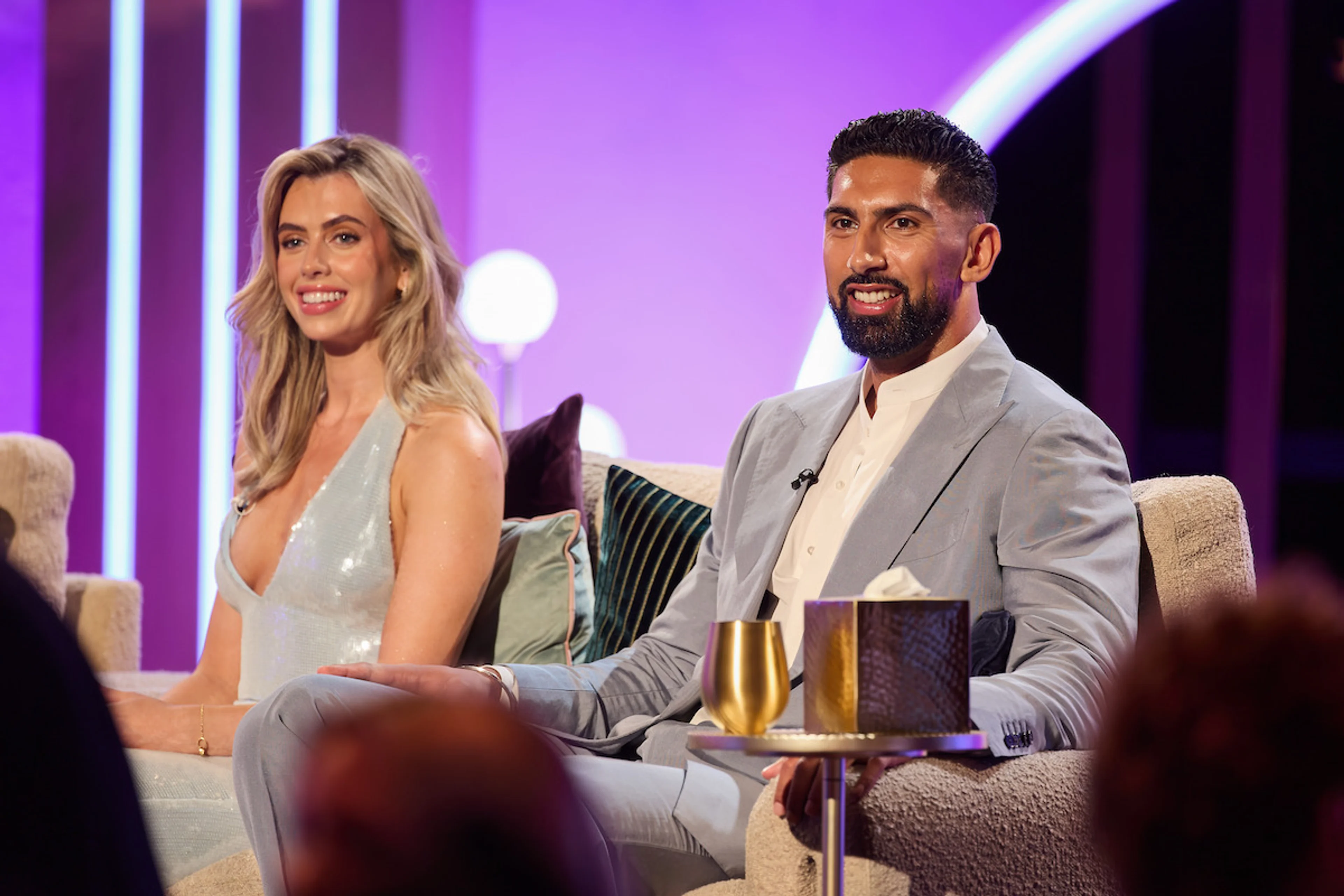 Ciara and Ajay smile together on the Love Is Blind UK Season 3 reunion set.