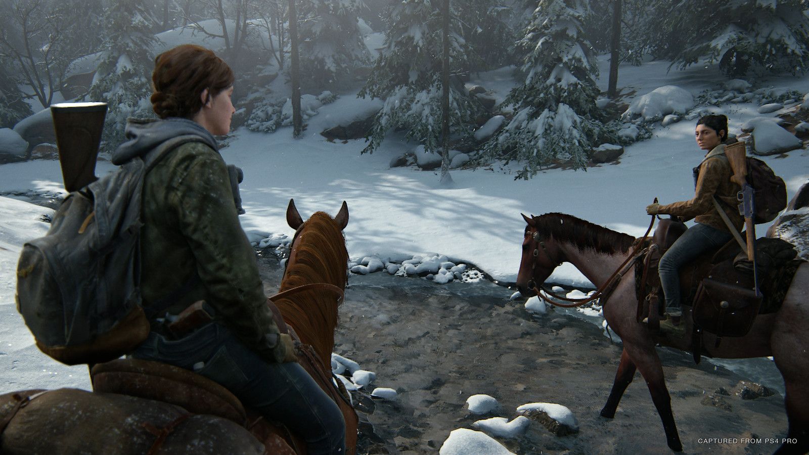 Ellie sits on horseback beside Dina in a snow-covered forest.