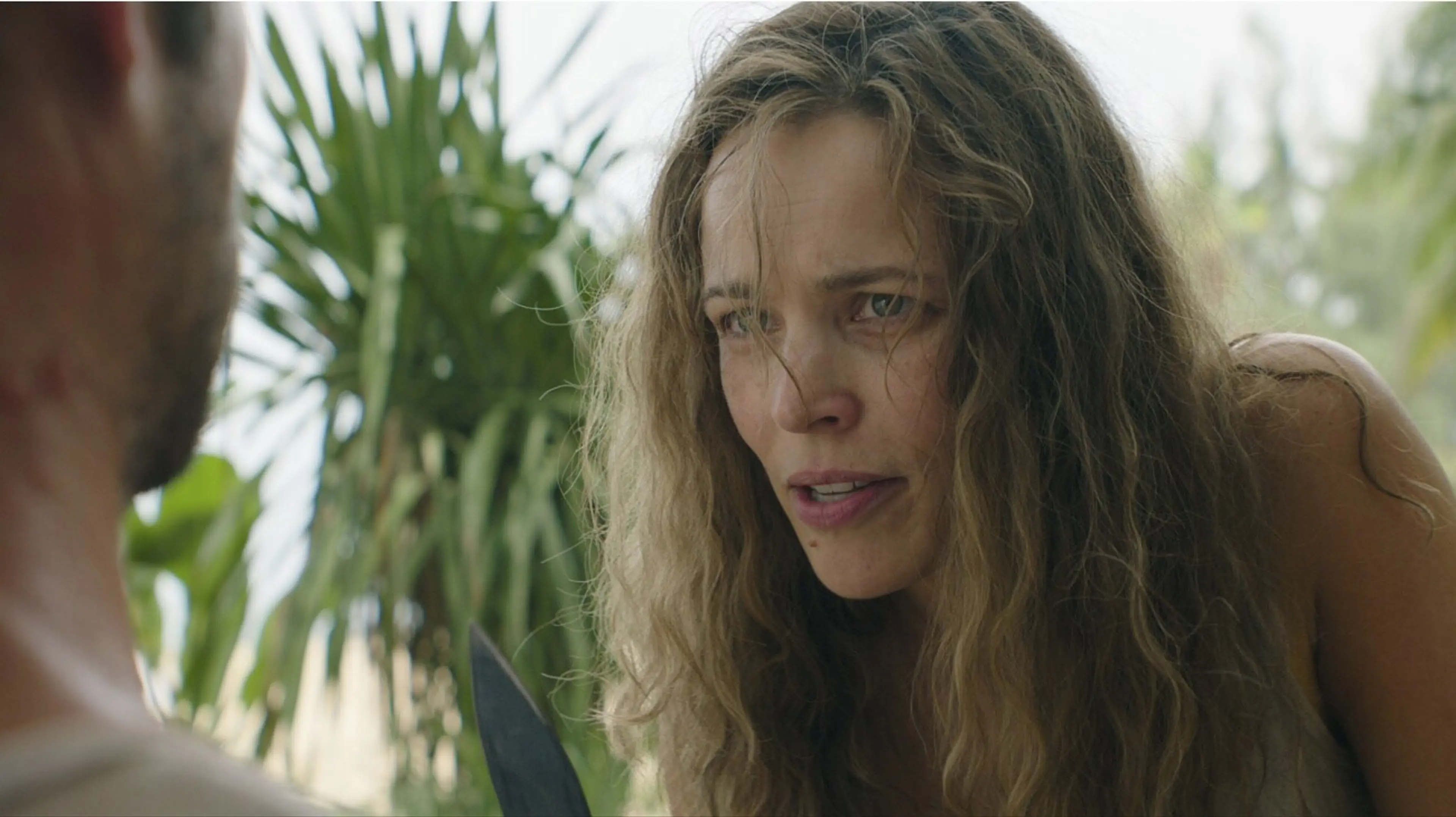 Linda leans close to Bradley with a knife visible at the bottom of the frame.