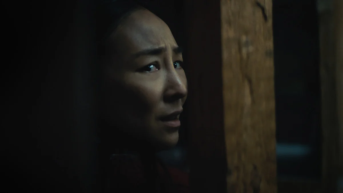 Greta Lee as Ann inside the house in Netflix's The Last House