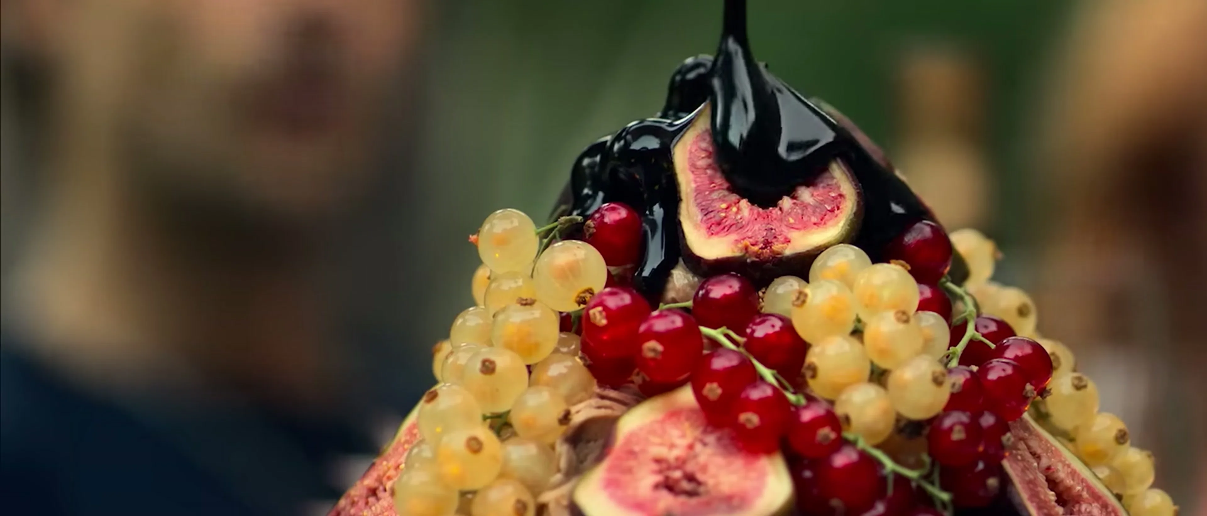 An elaborate fruit-topped course is served at a dinner club table in The Perfect Lie.