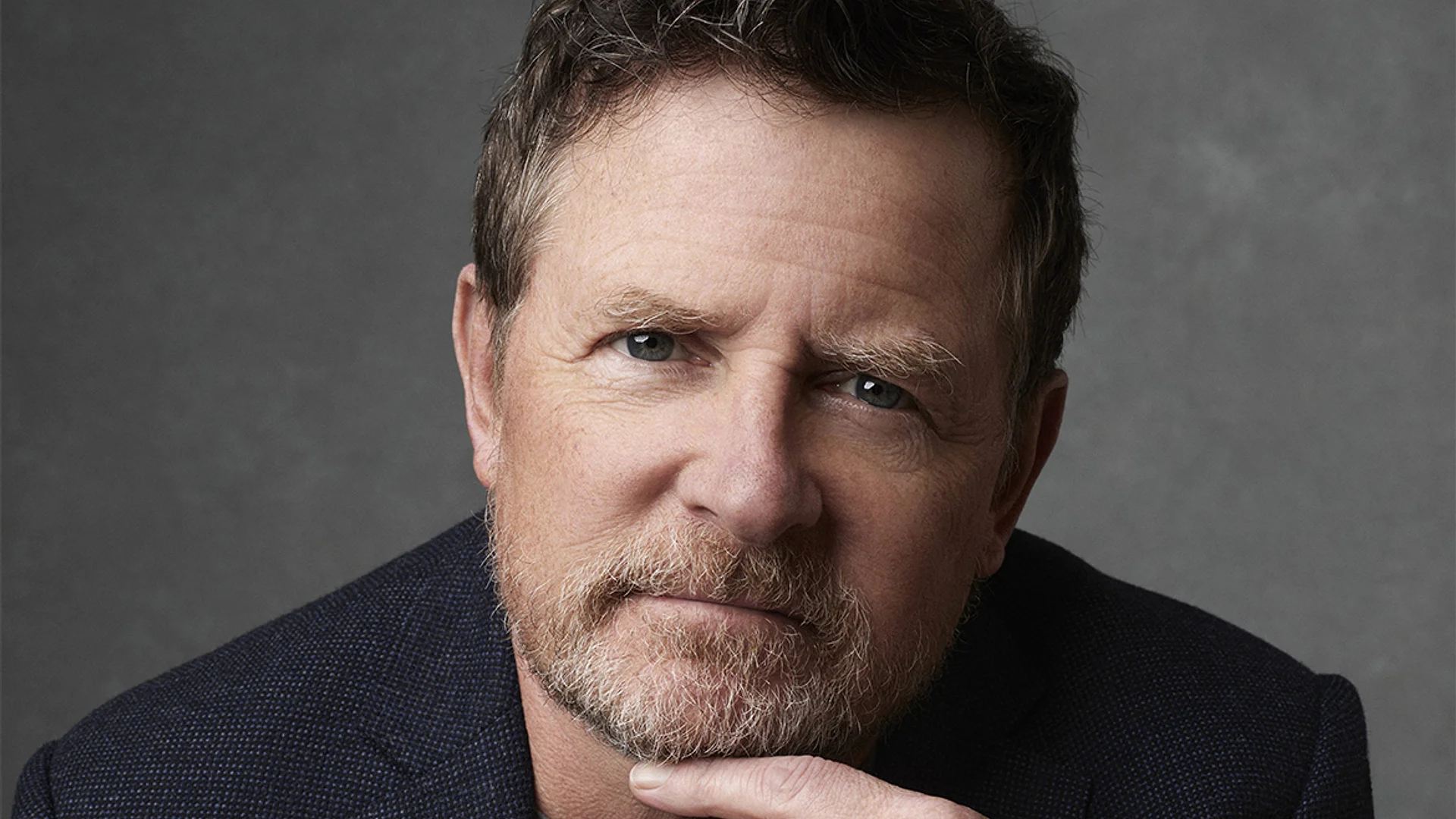 Michael J. Fox looks toward the camera in an official portrait.