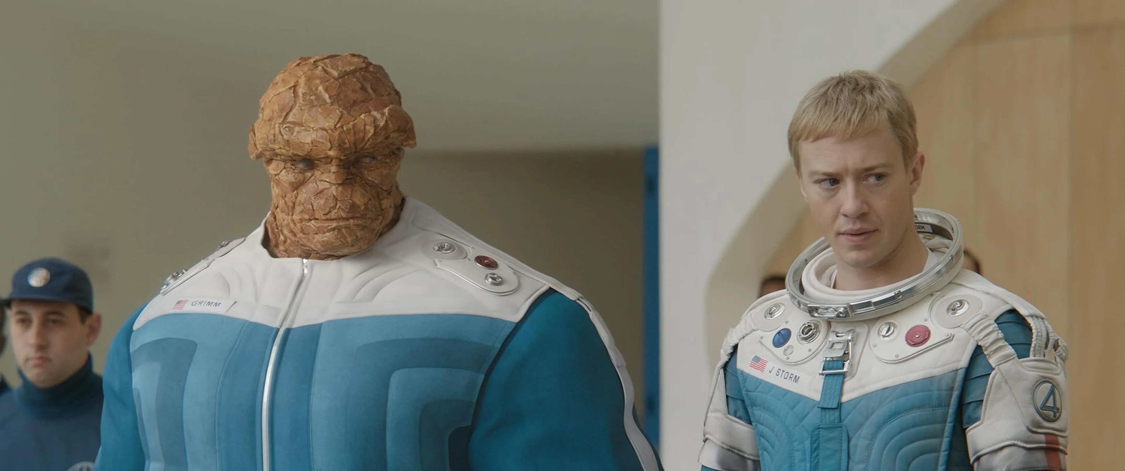 Ben Grimm and Johnny Storm stand together in Fantastic Four astronaut suits.