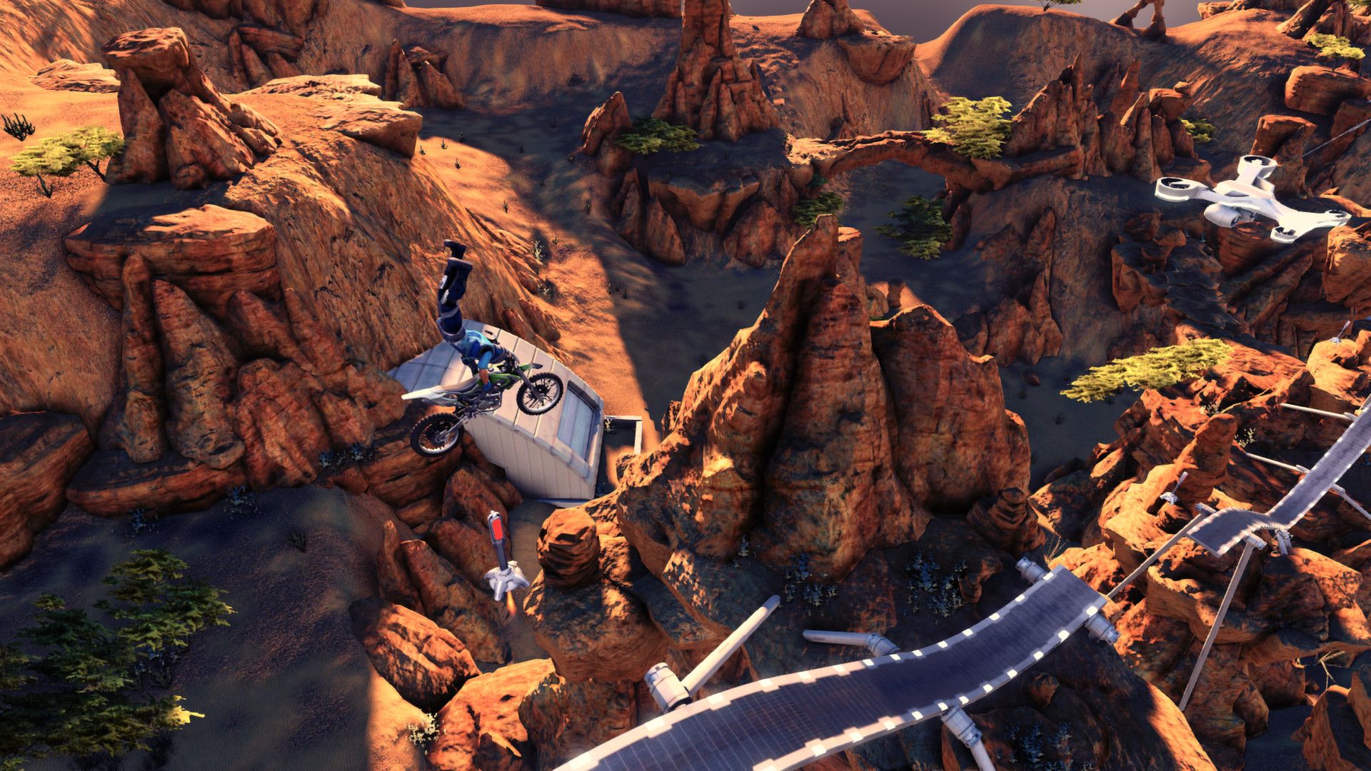 A rider navigates a narrow ramp through a rocky canyon.