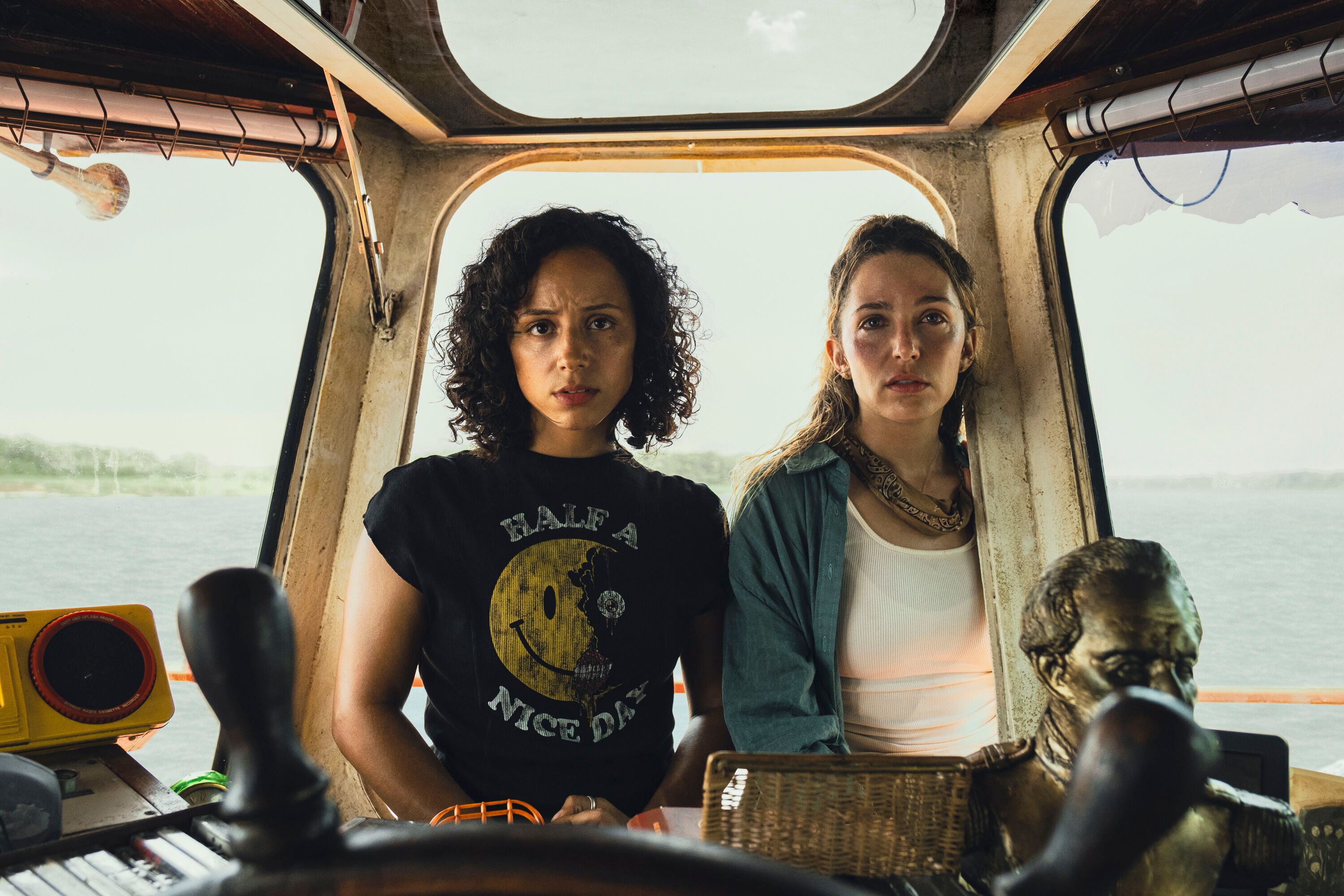 Kiana Madeira and Jessica Rothe stand inside a boat cabin on the Amazon.