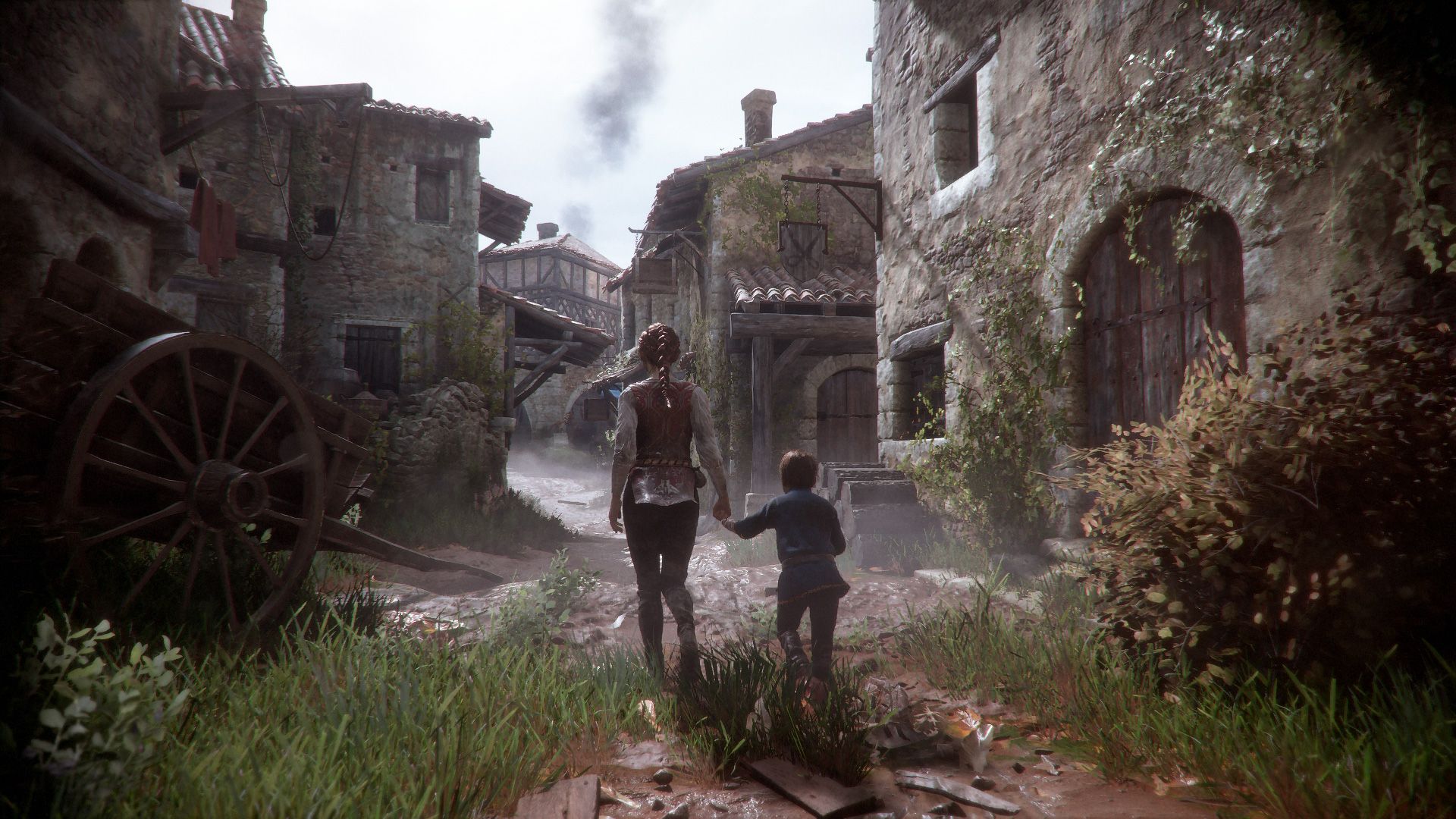Amicia and Hugo walk through a rough medieval village between stone buildings.
