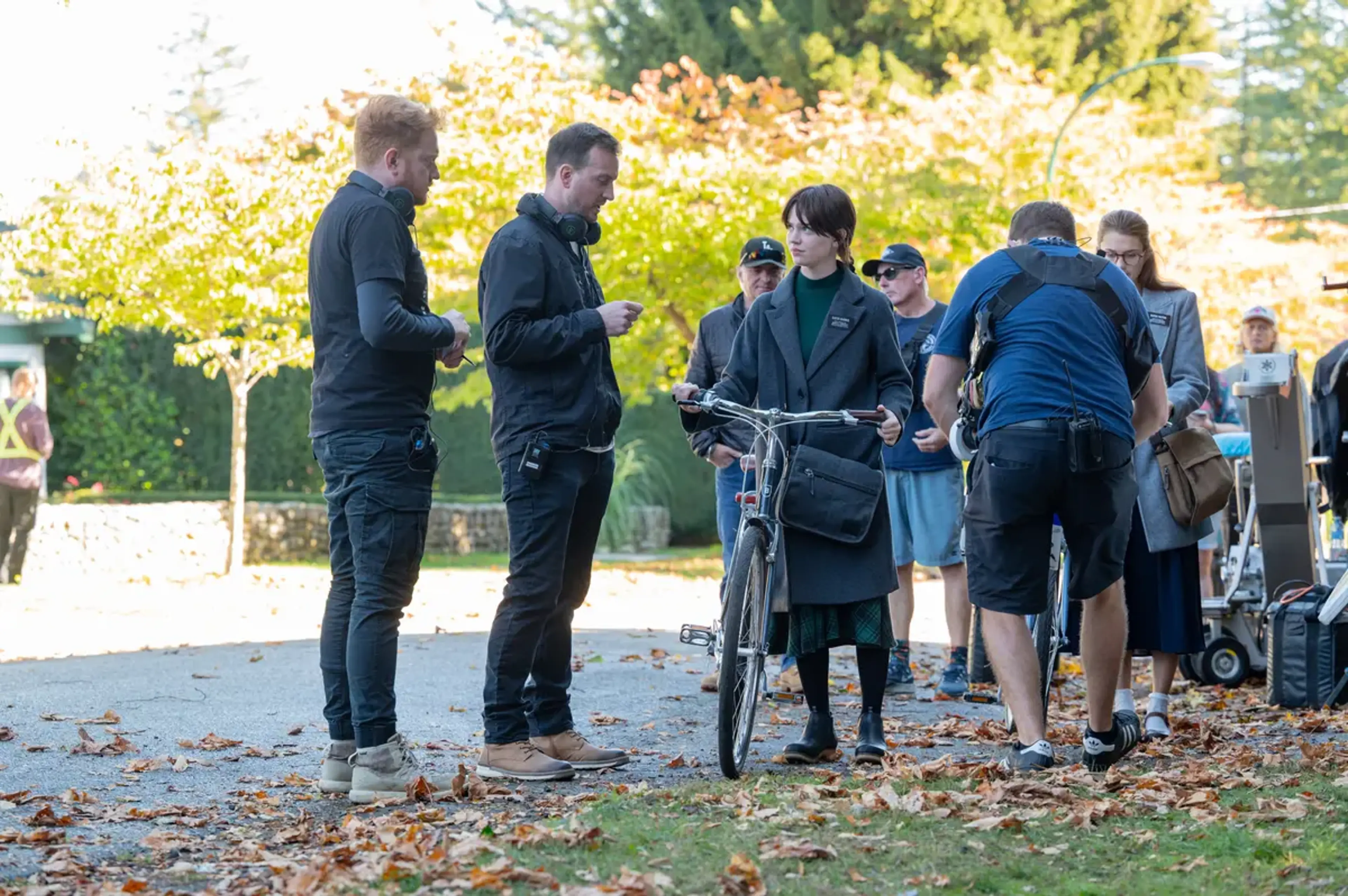 The filmmakers and actors stand together with bicycles on the Heretic set.