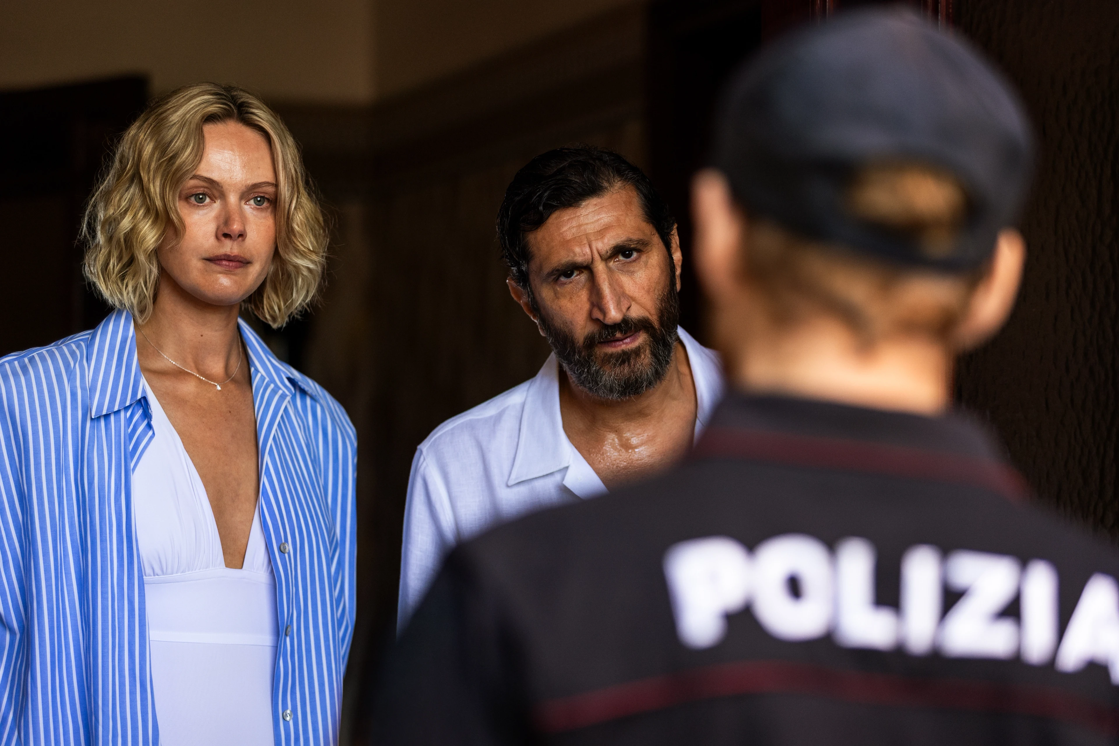 Frida Gustavsson as Helene and Fares Fares as Carl face an Italian police officer in A Couple of Lies.
