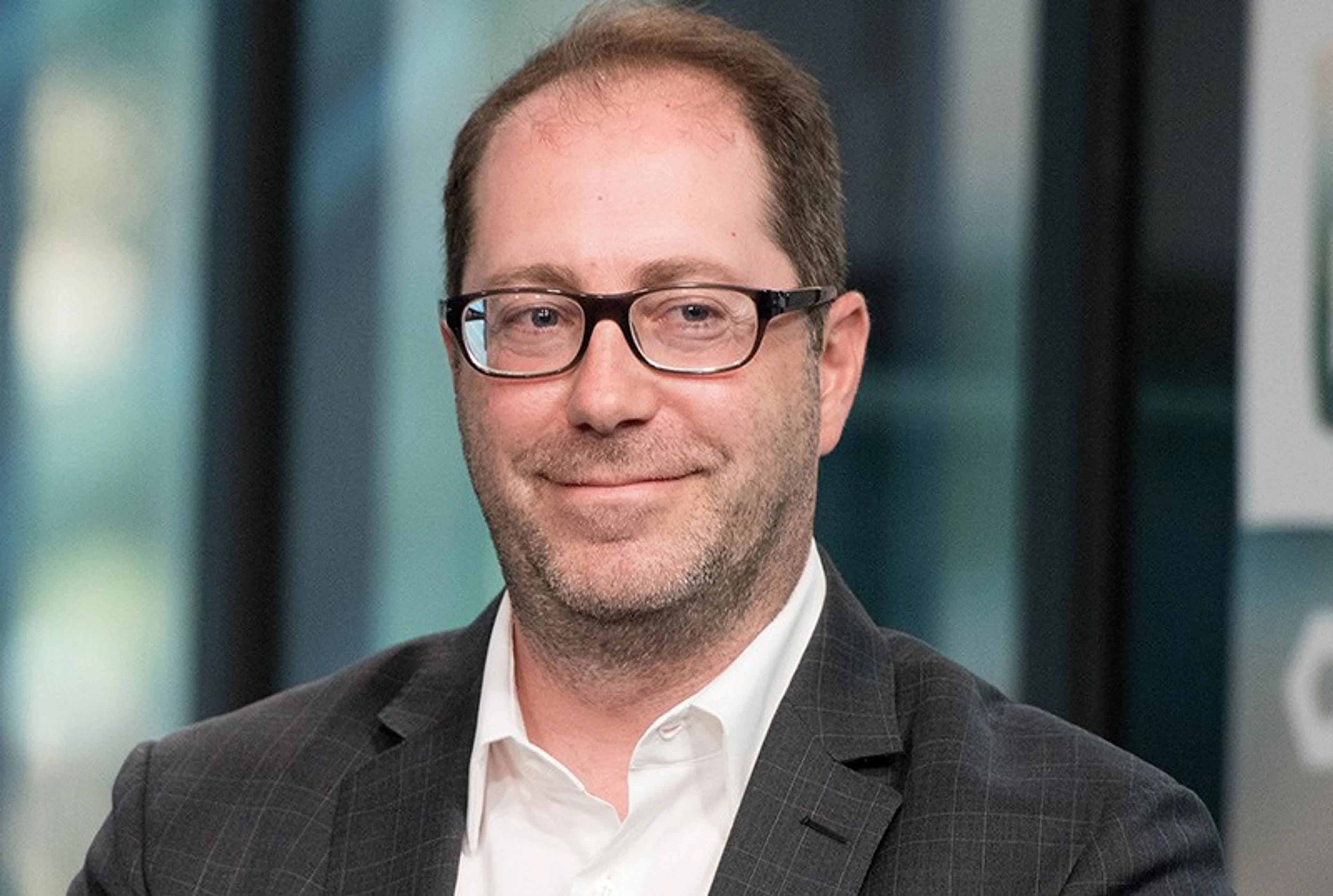 Craig Silverstein wears glasses and a dark jacket in a portrait.