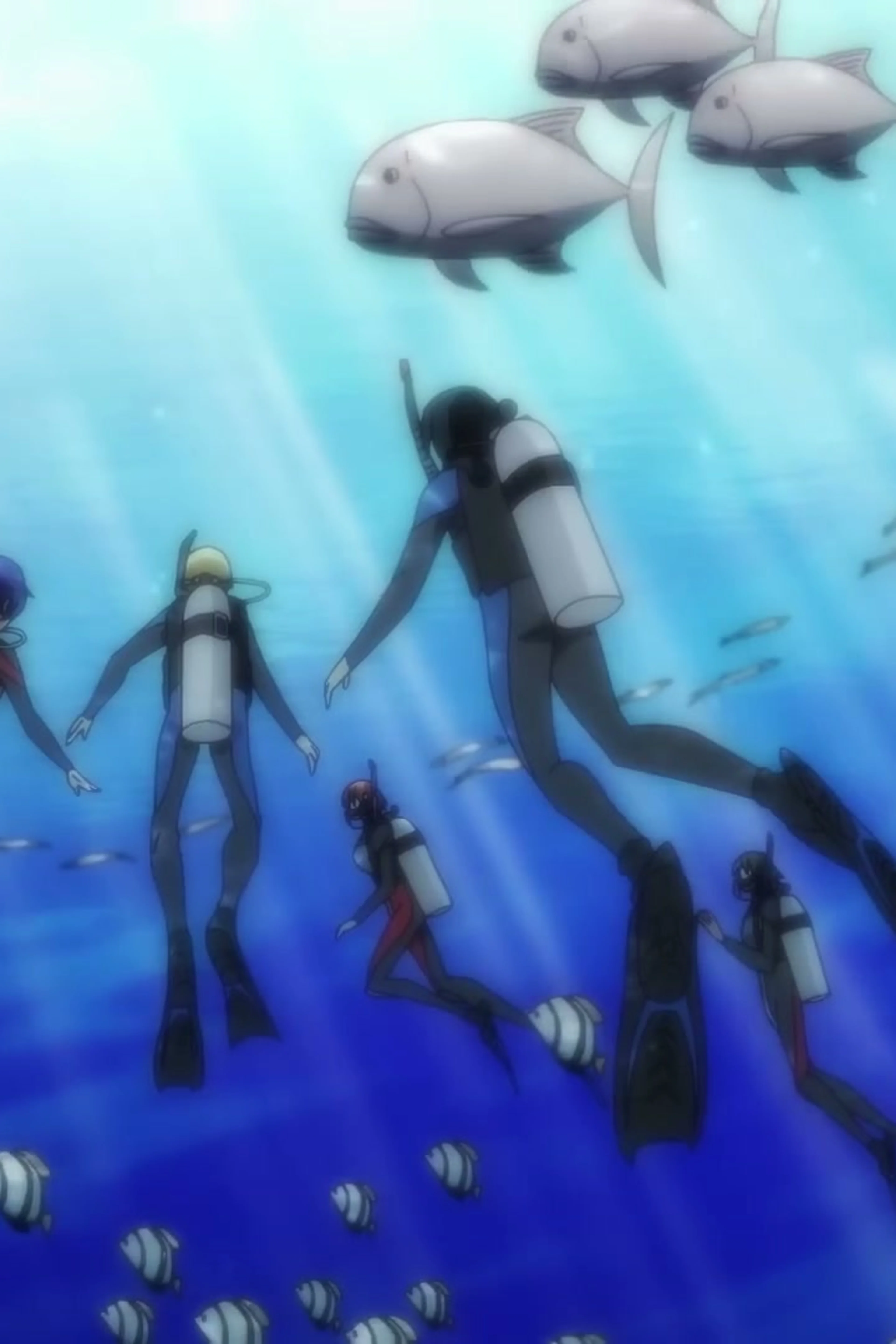 The Grand Blue Dreaming group dives through clear blue water.