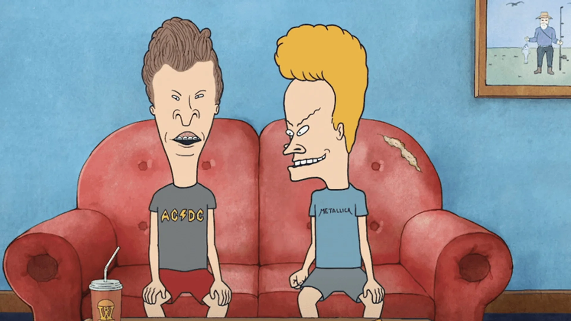 Beavis and Butt-Head sit together on their familiar red couch in an official promotional still.