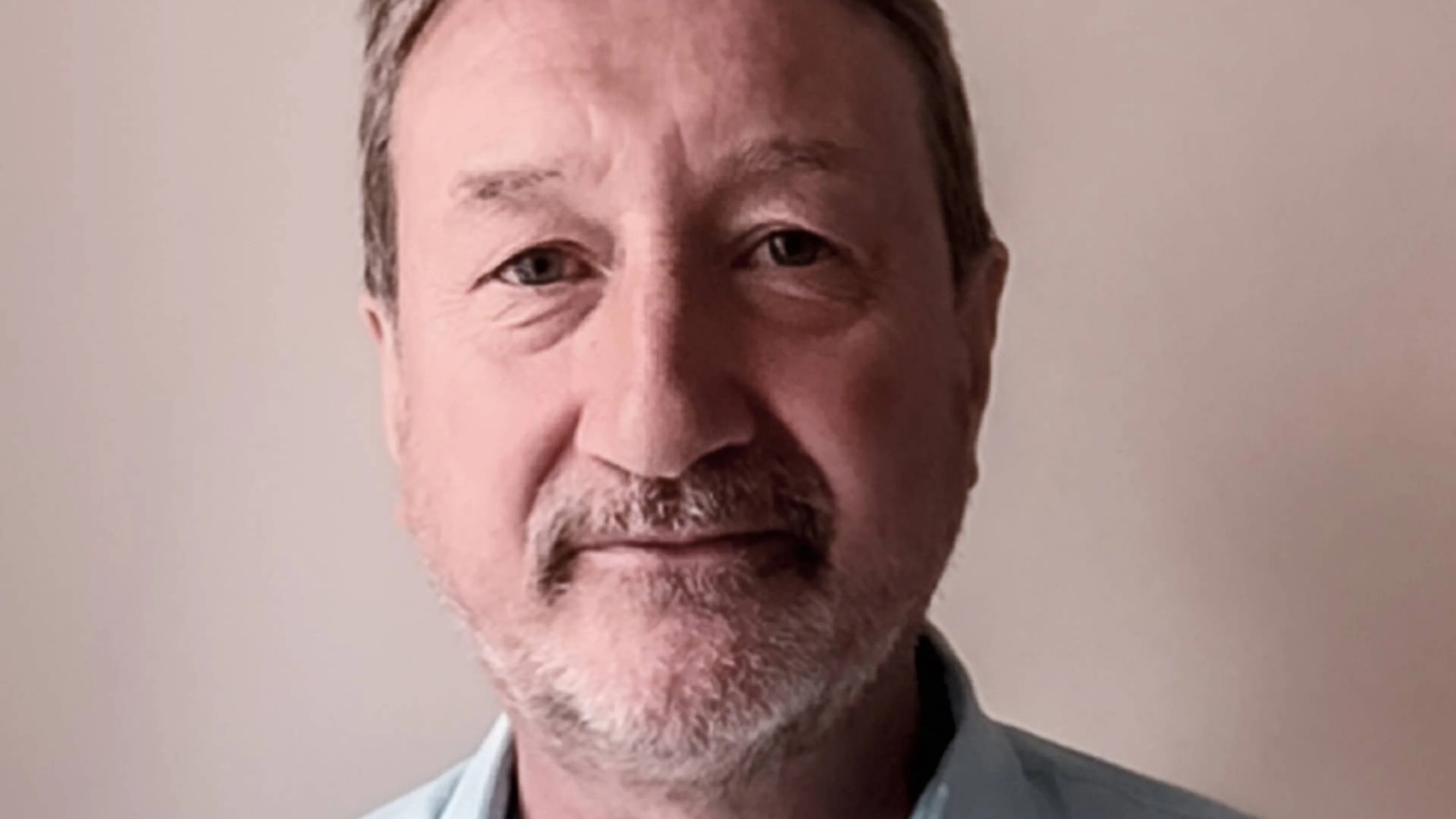 Screenwriter Steven Knight faces the camera in the official James Bond announcement portrait.