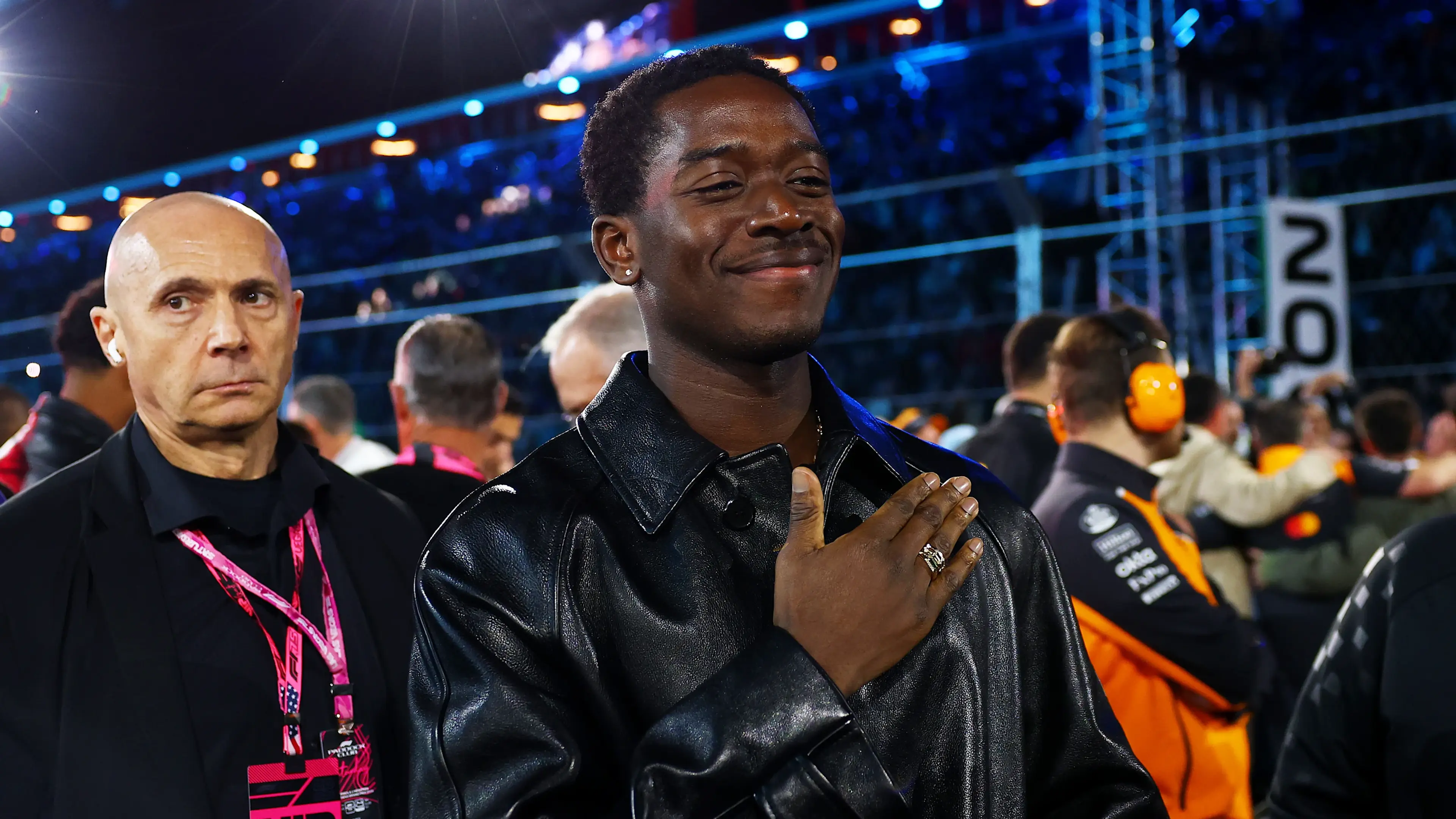 Damson Idris stands in front of a Formula 1 car at the Las Vegas Grand Prix.