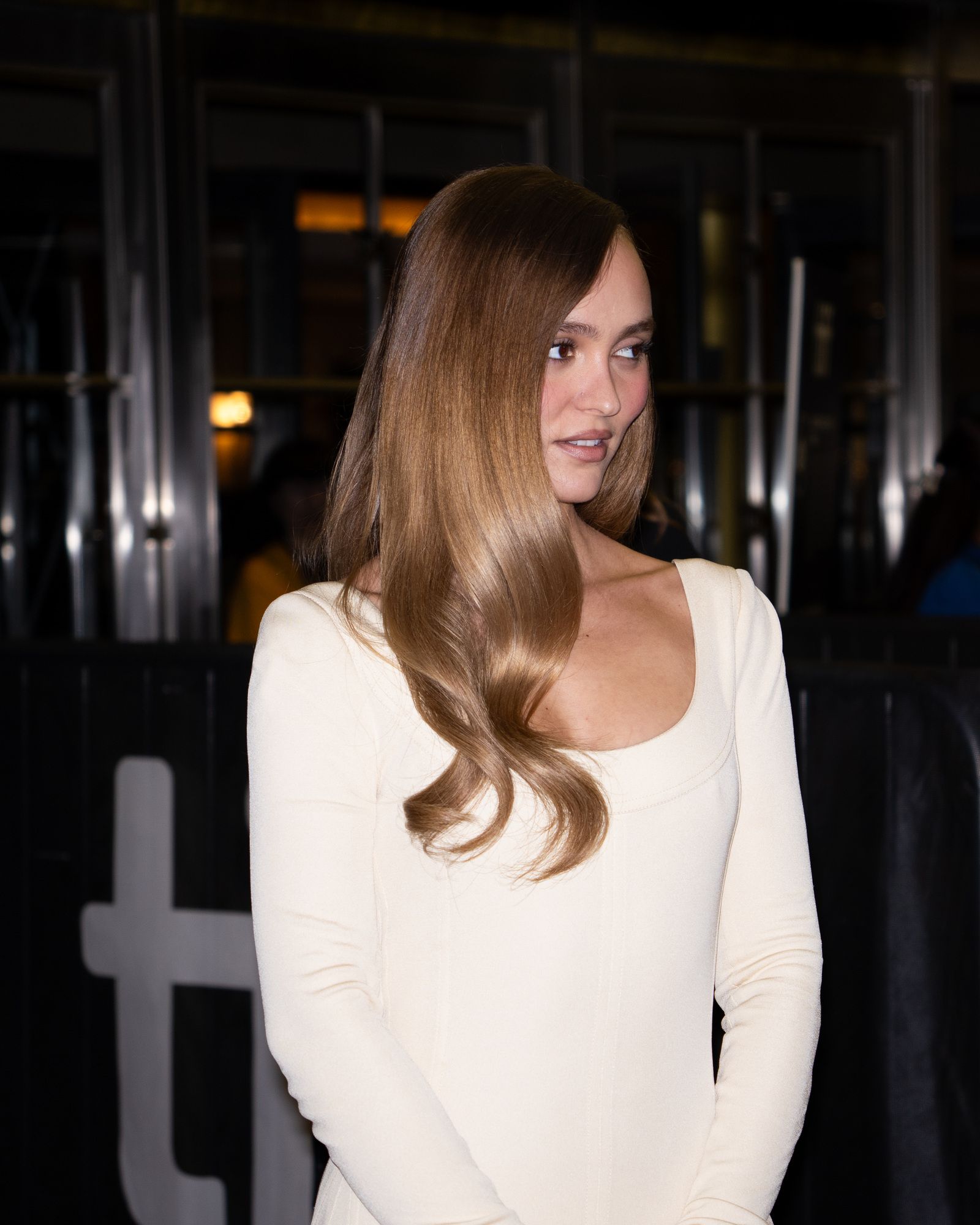 Lily-Rose Depp wears a white dress at the 2026 Toronto International Film Festival.