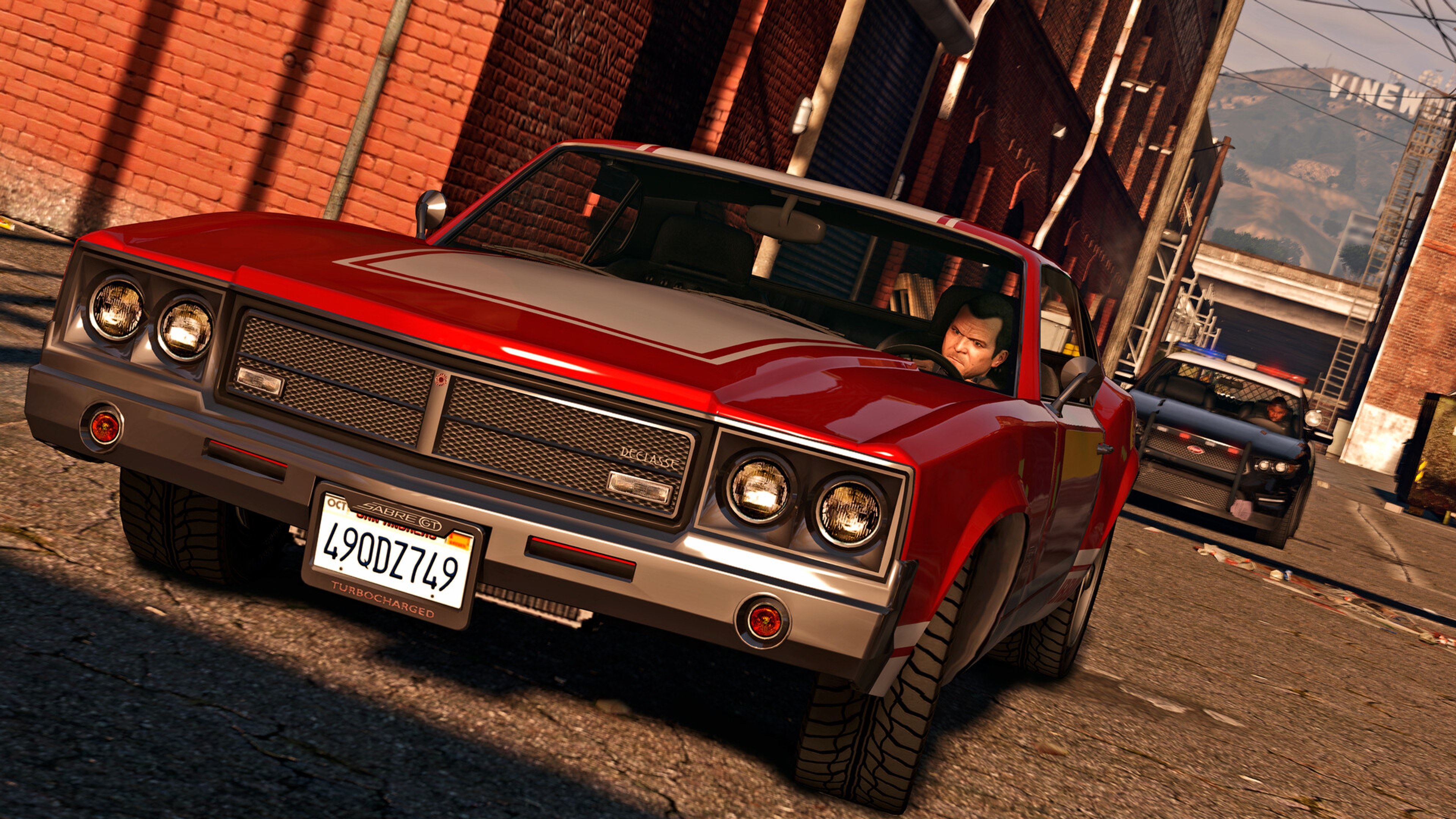 Michael drives through Los Santos with police close behind in GTA 5.