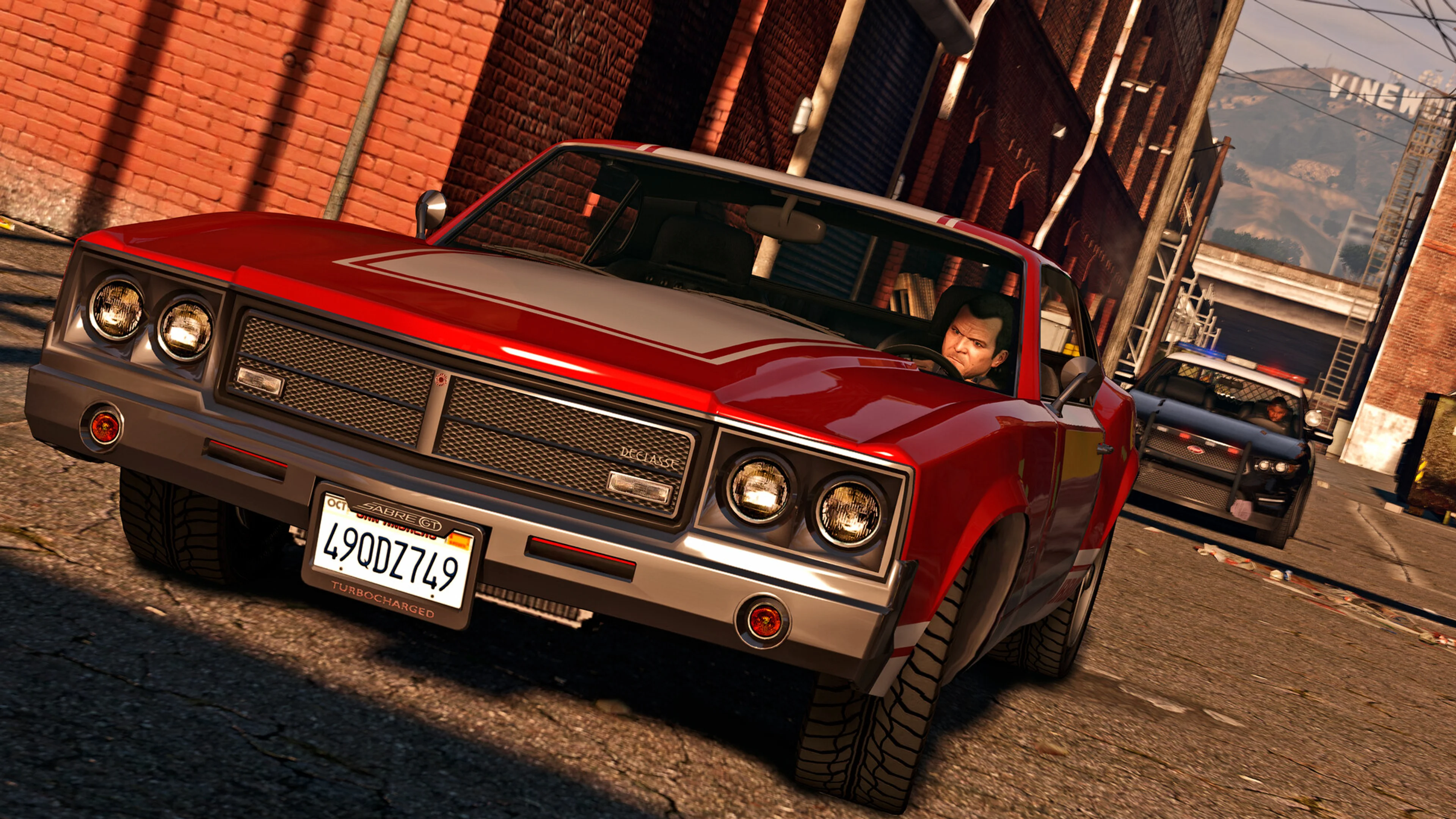 Michael drives through Los Santos with police close behind in GTA 5.