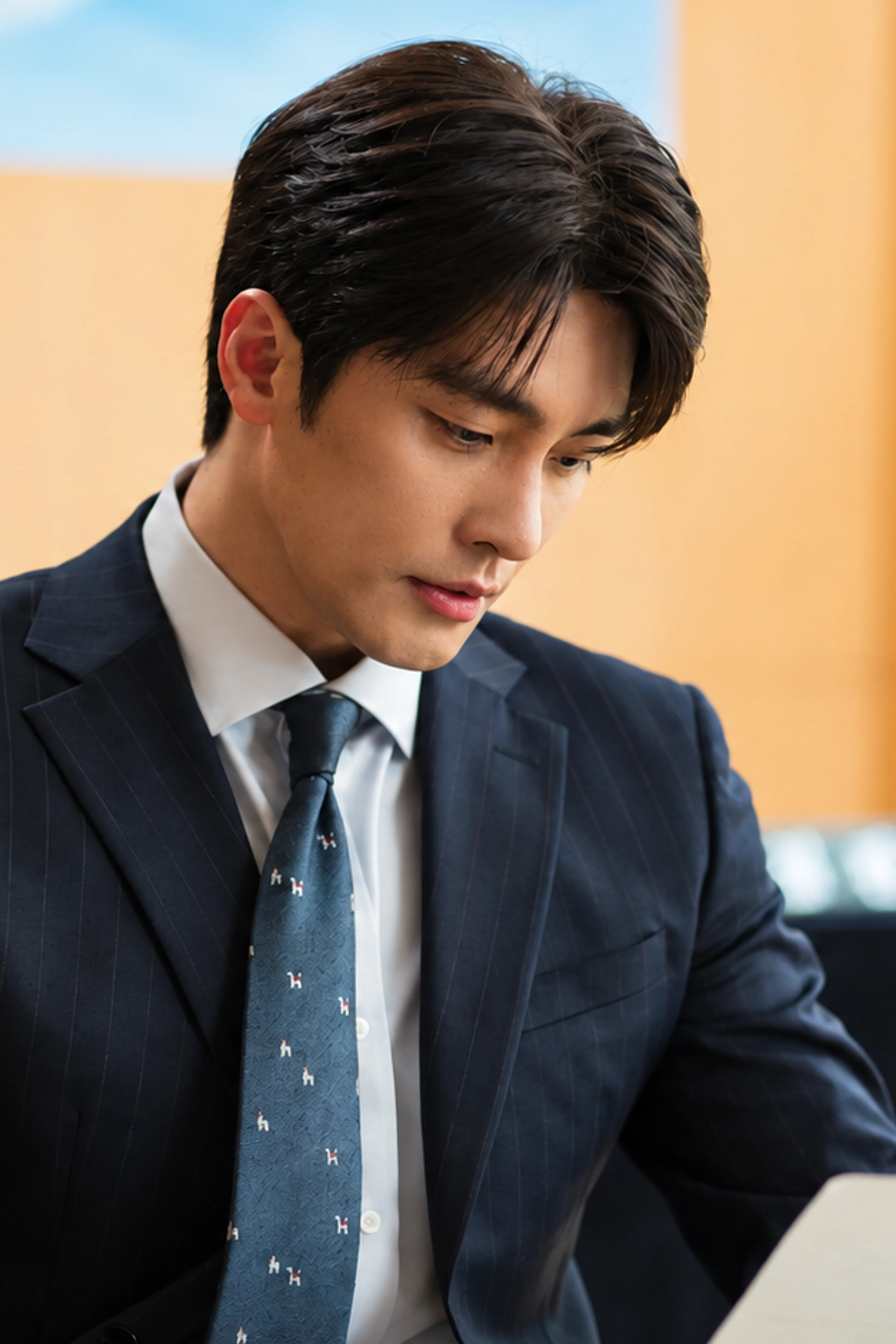 Sung Hoon as Kwon Do-hyuk looks down at a document in What a Boss Wants.
