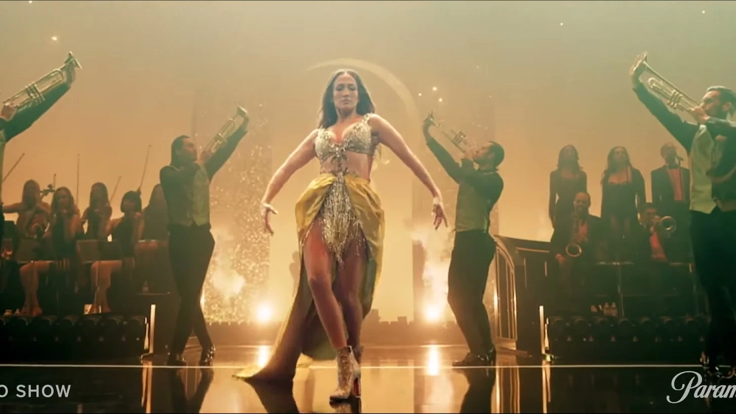 Jennifer Lopez performs onstage with dancers and a live ensemble in The JLO Show.