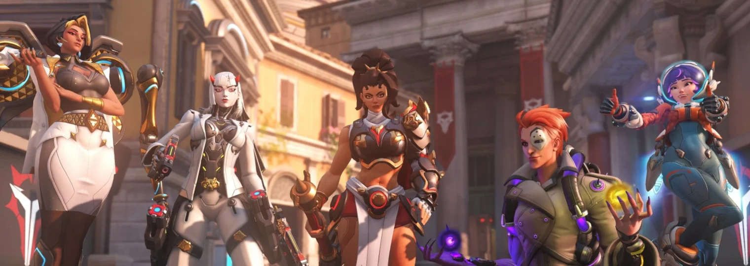 Five Overwatch heroes pose together in a sunlit city.