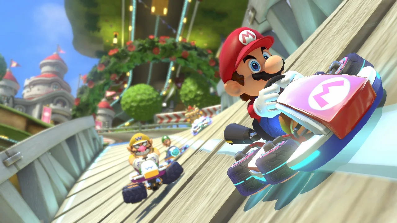Official Mario Kart 8 Wii U gameplay screenshot showing Mario driving sideways on an anti-gravity wall with blue-glowing wheels.