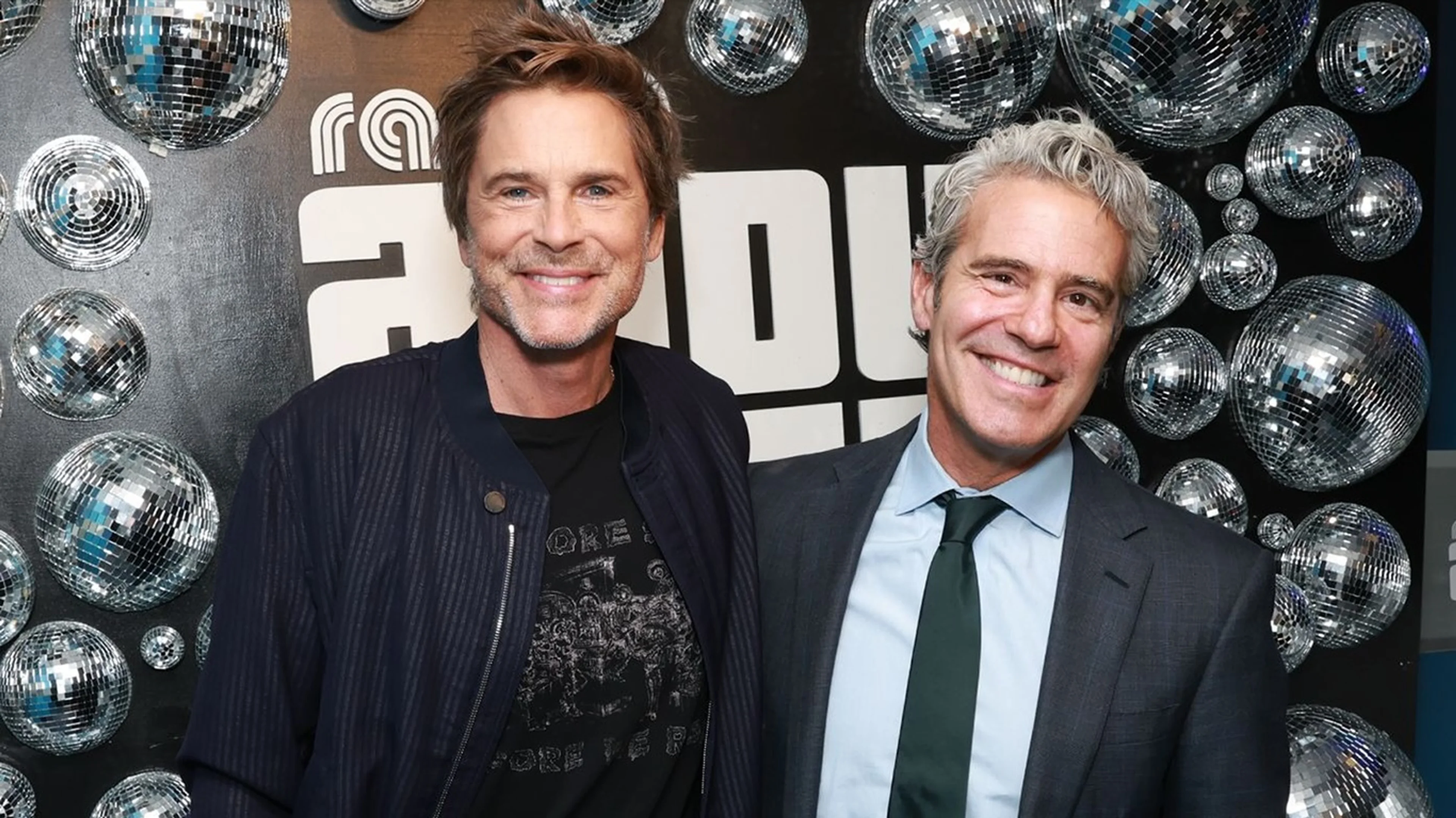 Rob Lowe sits beside Andy Cohen at SiriusXM.